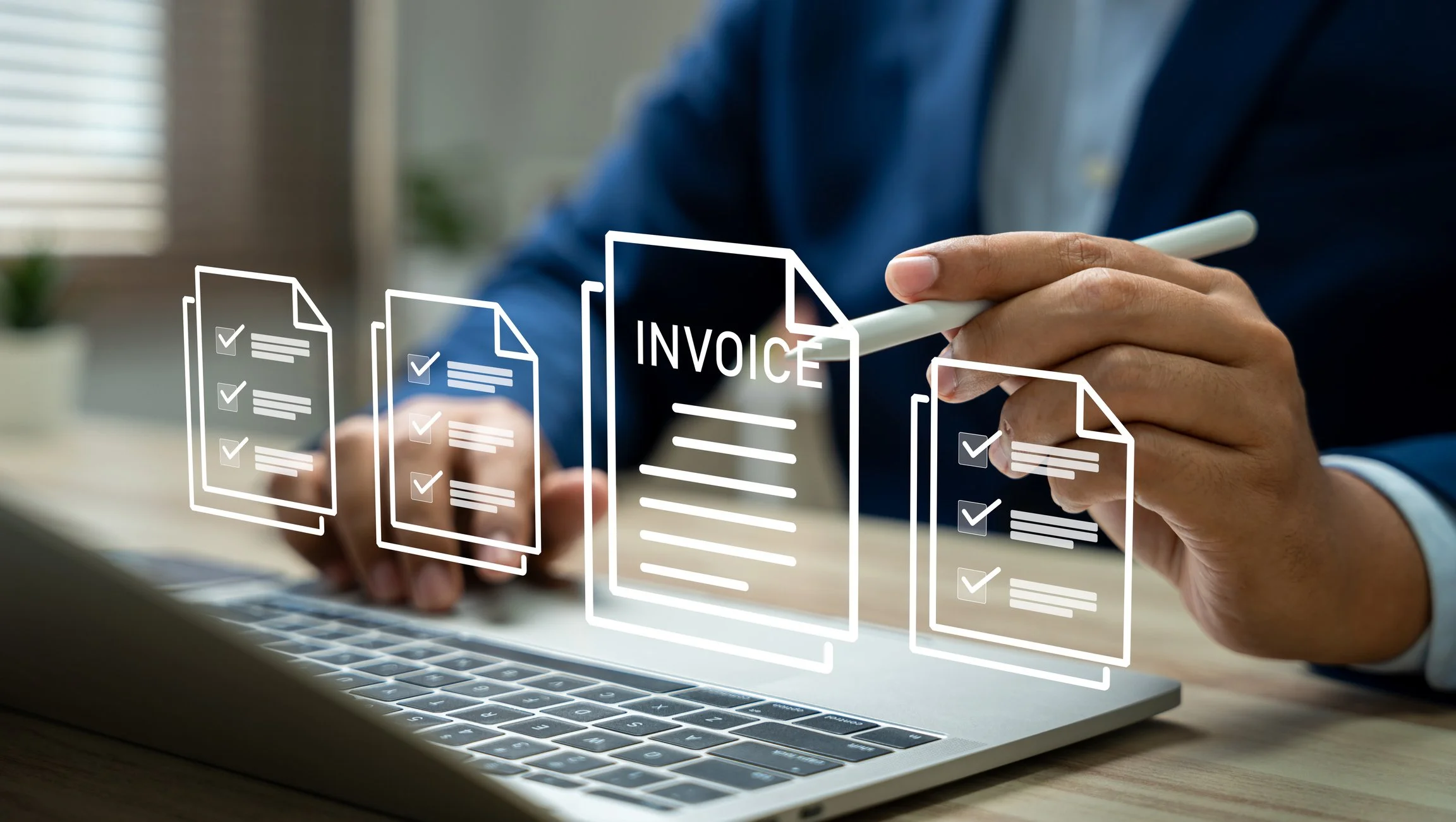 Person in business suit using a stylus to select digital invoices on a laptop with holographic invoice icons displayed.
