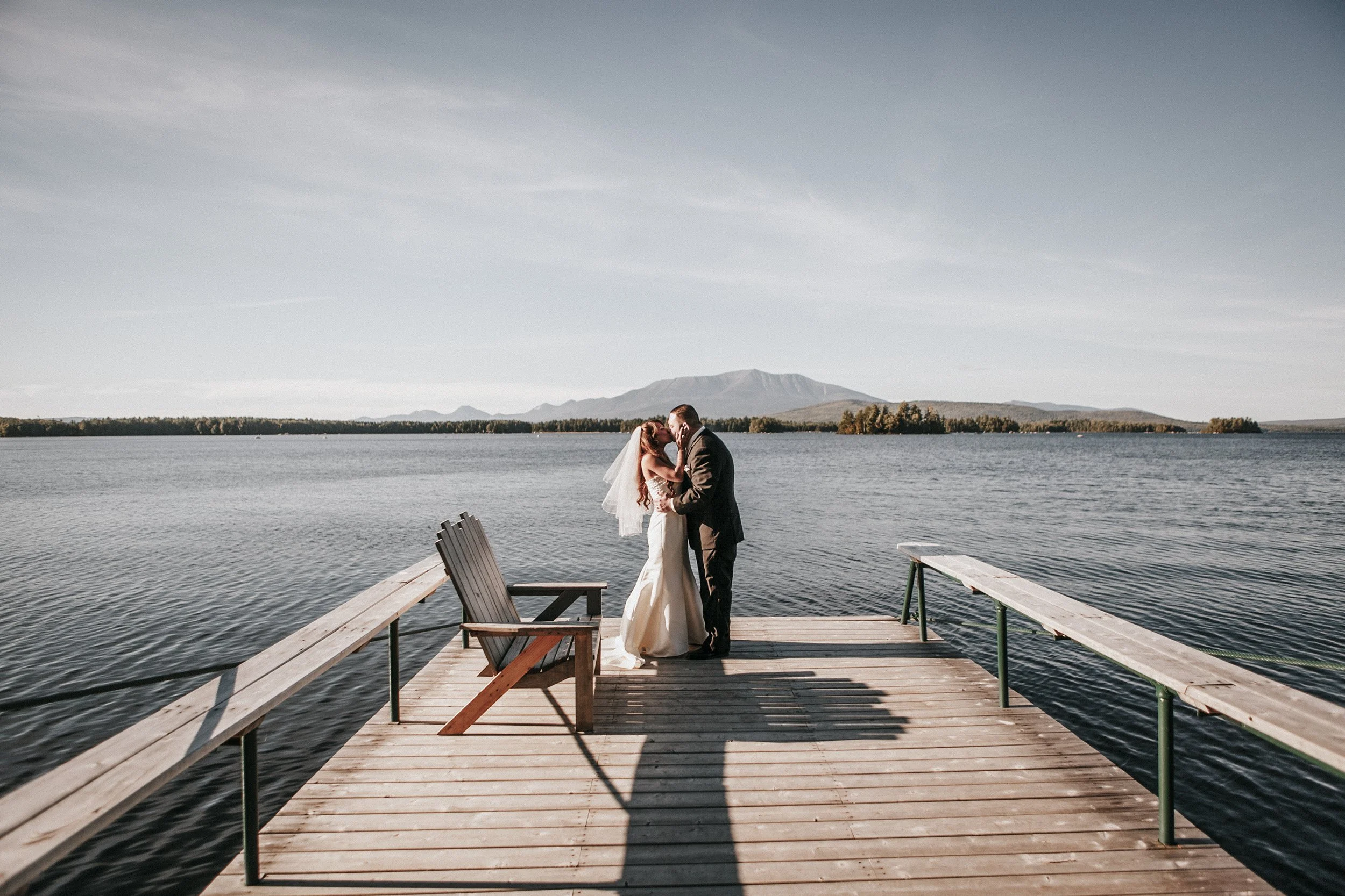 Couple kisses on the dock at North East Outdoor Center 