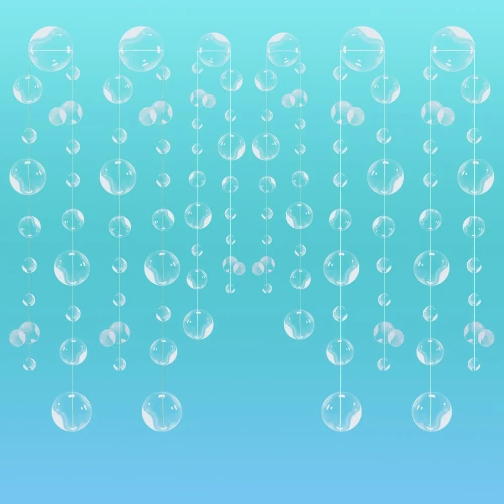 Multiple strands of hanging transparent bubbles against a light blue background.
