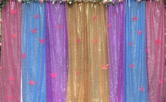 Colorful fabric backdrop with pink butterfly decorations