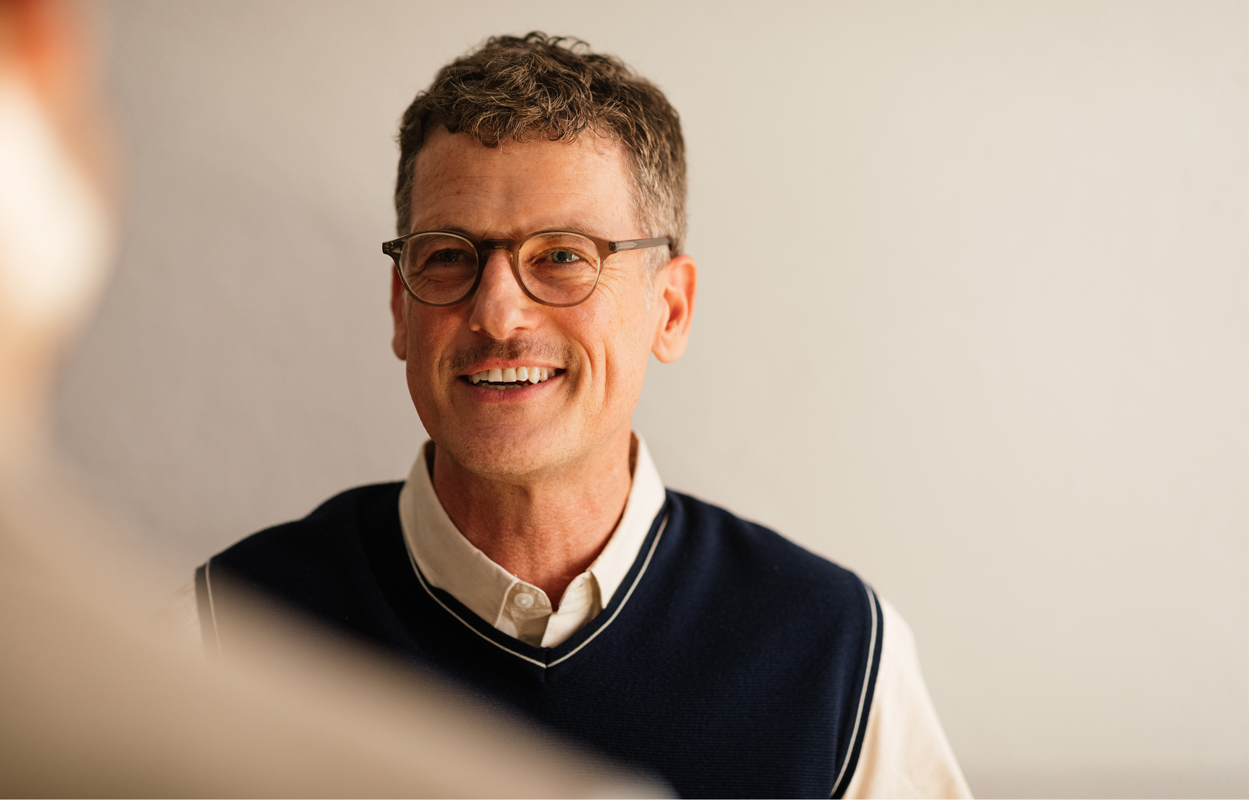 Professional portrait of test prep founder smiling at the camera.