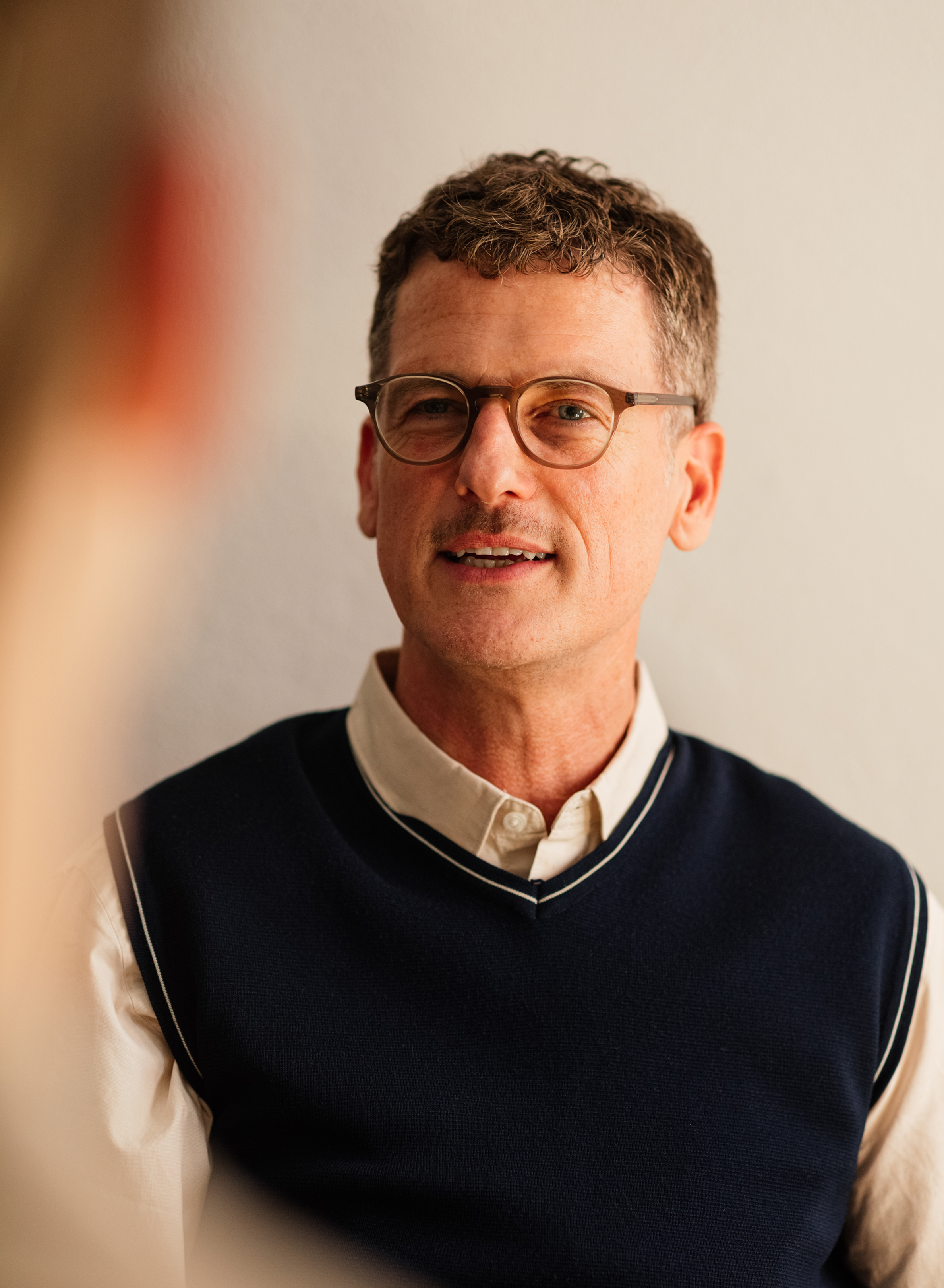 Professional portrait of test prep founder smiling at the camera.