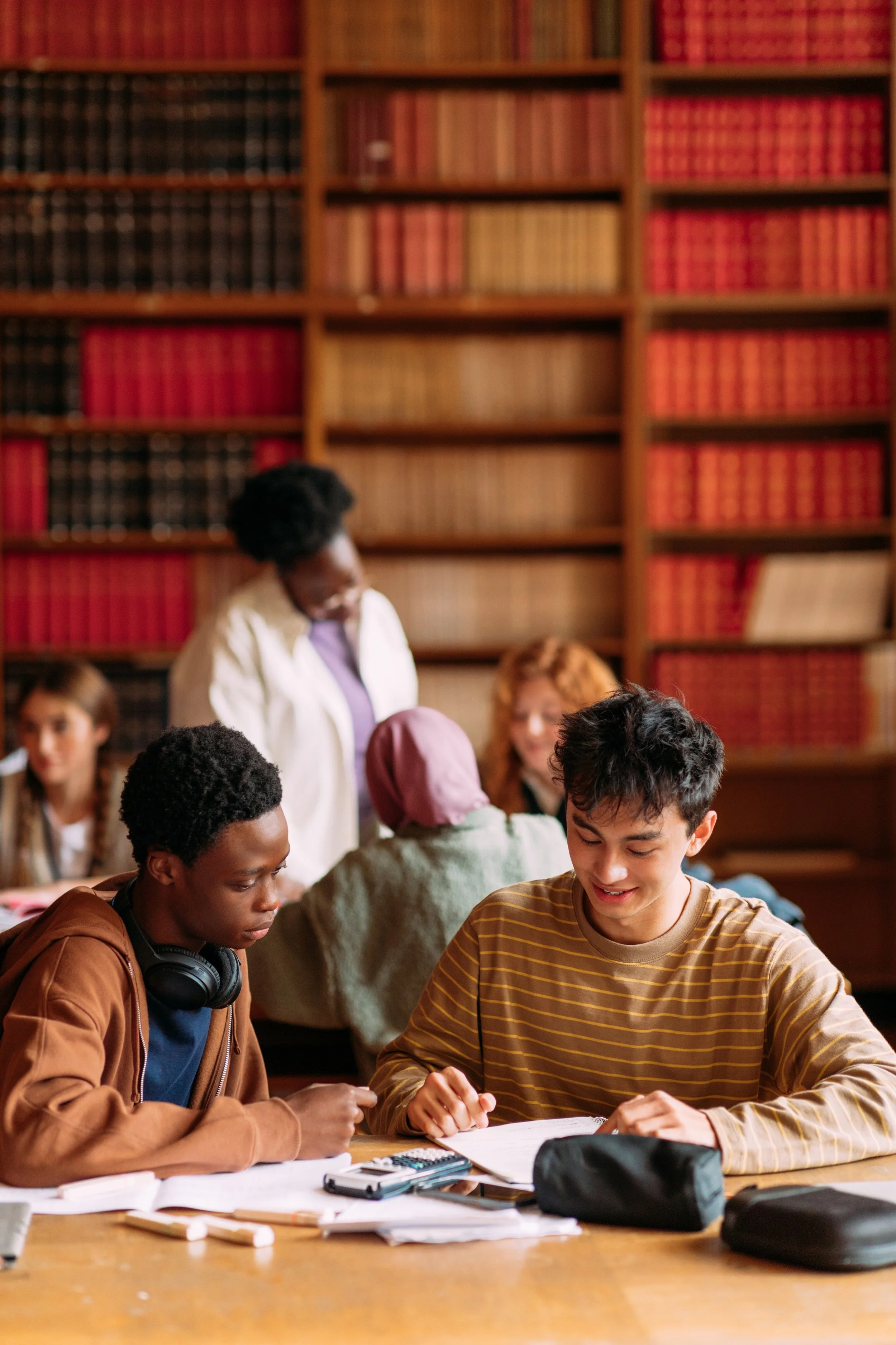 Two students studying together in a test prep group course setting.