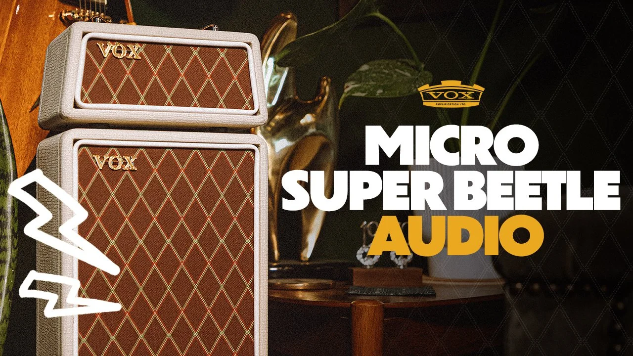 Vox Micro Super Beetle audio speakers on a wooden surface, with a decorative plant and a small statue in the background. Text overlay reads 'Vox Micro Super Beetle Audio'.