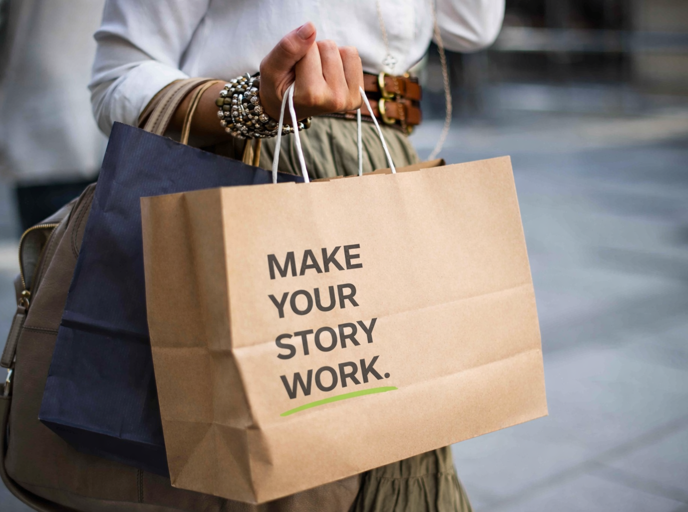 Retail shopping bag with “Make Your Story Work” branding and green underline detail