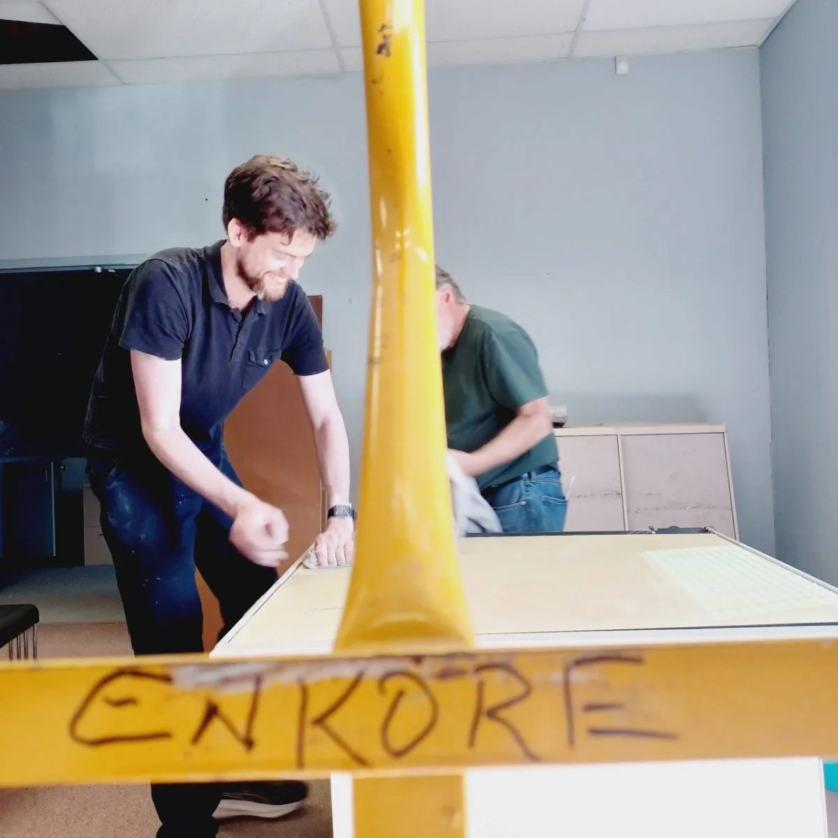 Team members dismantling cubicles with EnKore hand truck during theatre build-out in Woodland, CA.