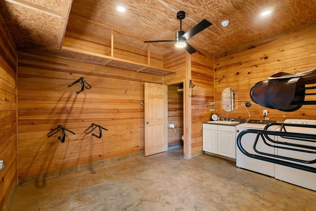 Tack room has half bath, sink, washer and dryer.