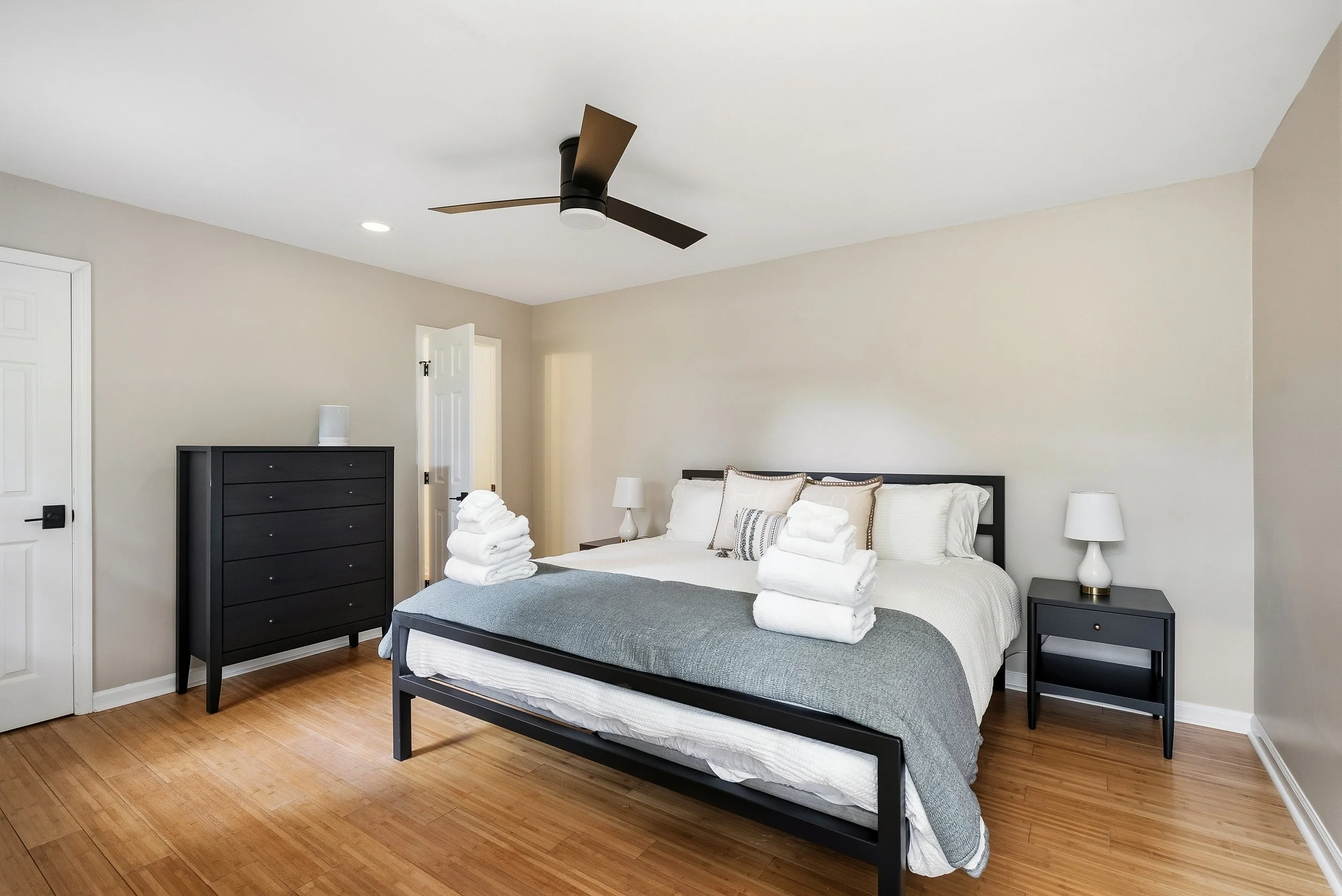 Spacious bedroom with king-size bed and dresser.