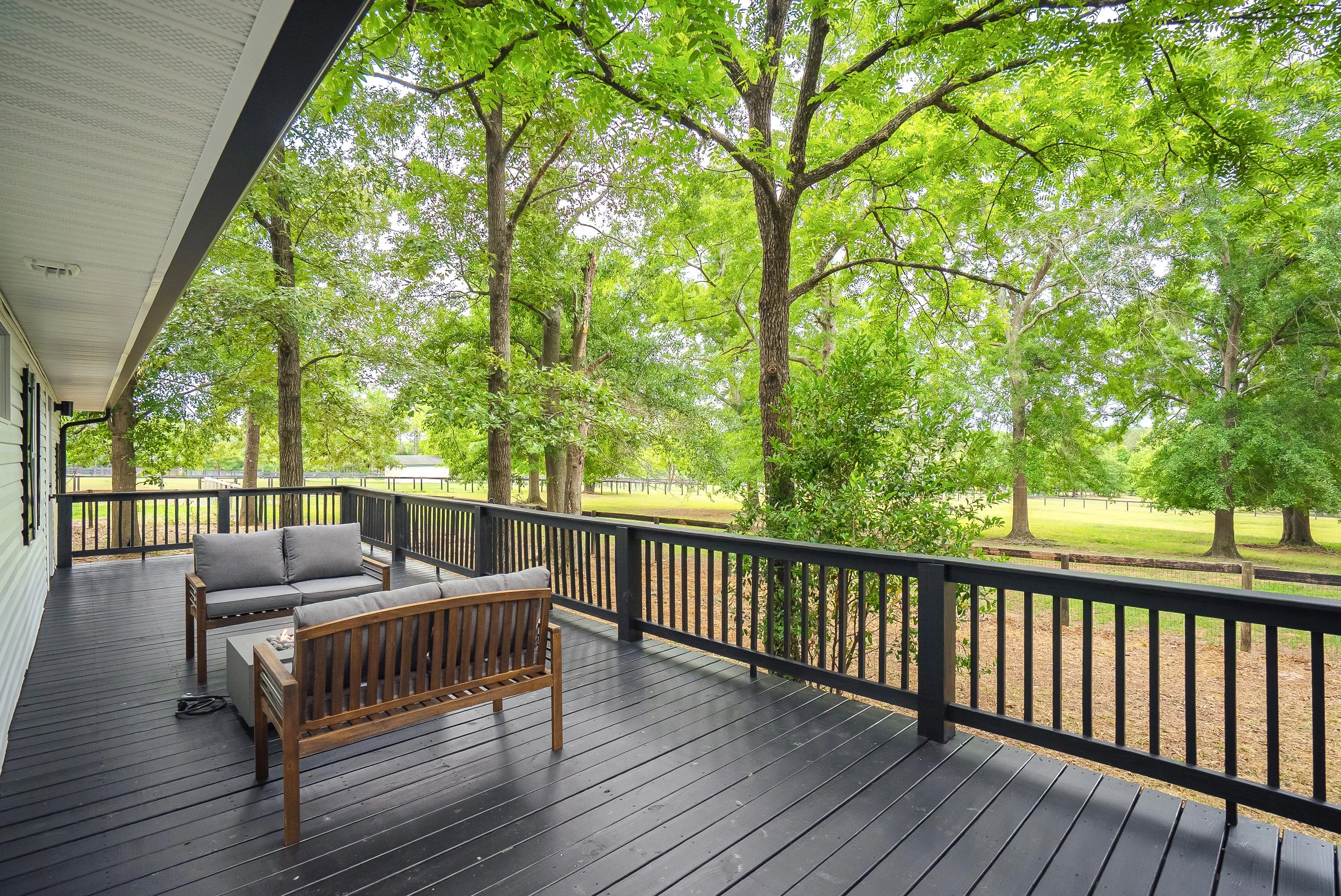 Enjoy a beverage on the back deck while looking out over the mature trees and sprawling pastures.