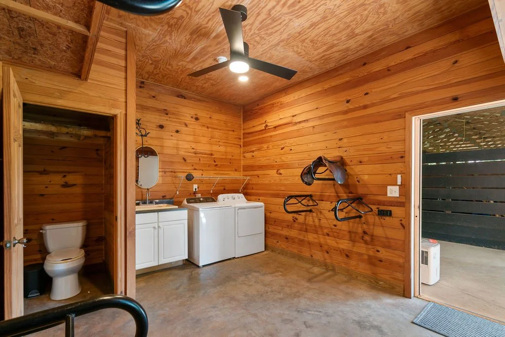 Half bath, sink, washer and dryer in tack room.  Grooming area just outside the door!