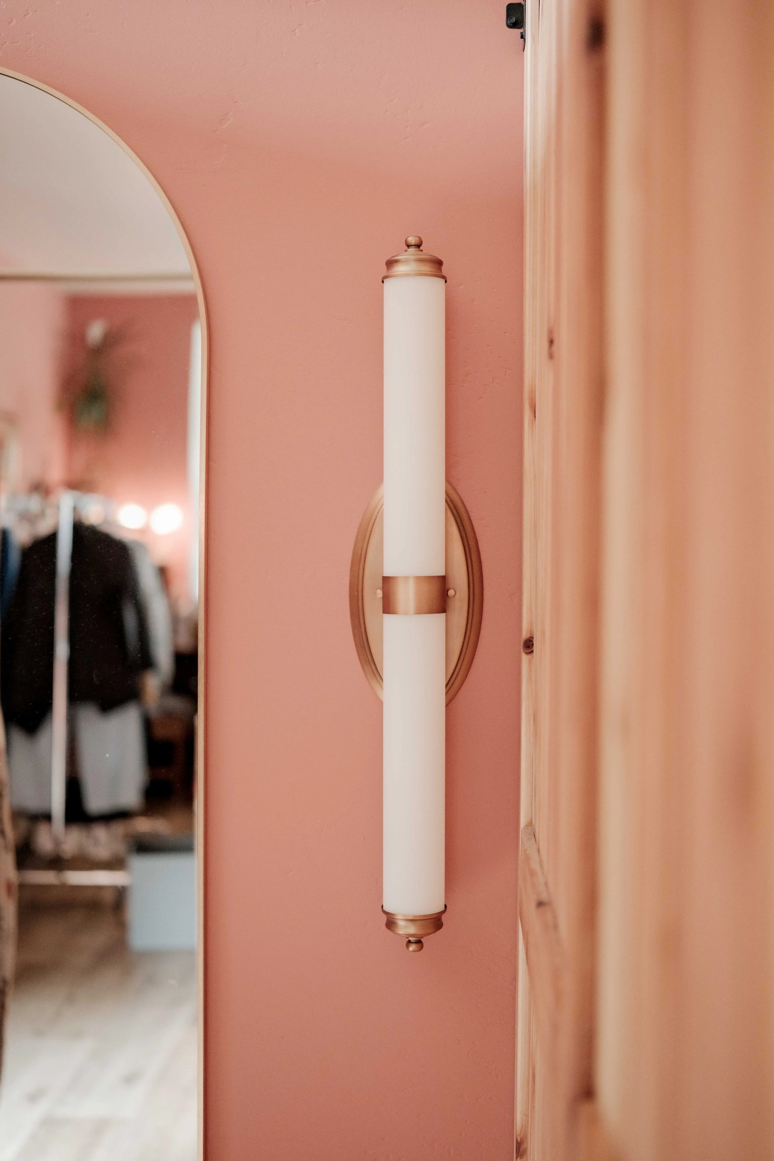 Wall sconce on peach wall