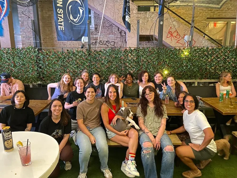 Multiple WLW individuals enjoying drinks on the patio of Parlor & Yard in Austin