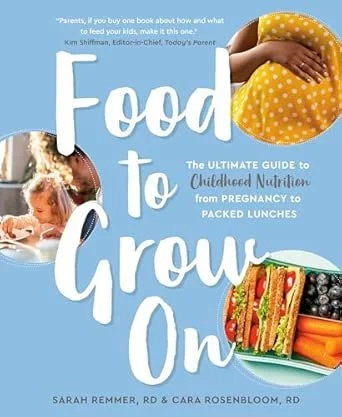 Book cover titled 'Food to Grow On: The Ultimate Guide to Childhood Nutrition from Pregnancy to Packed Lunches' by Sarah Remmer and Cara Rosenbloom, featuring a photo of a child's hand holding a polka-dotted yellow baby sock and an image of a bento box with vegetables and sandwiches.