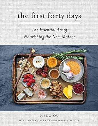 A book cover titled 'The first forty days: The Essential Art of Nourishing the New Mother' with a tray of various foods including eggs, berries, nuts, lemon, garlic, and herbs on a blue cloth background.