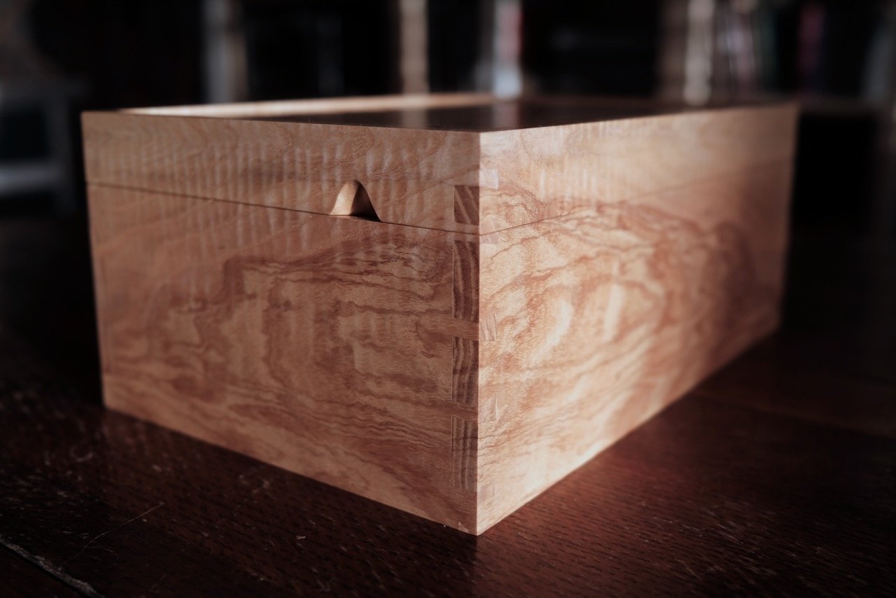 Closed Engagement Box in Devon rippled ash — grain wrapping continuously around all four sides, bespoke jewellery box by Henry Crabb