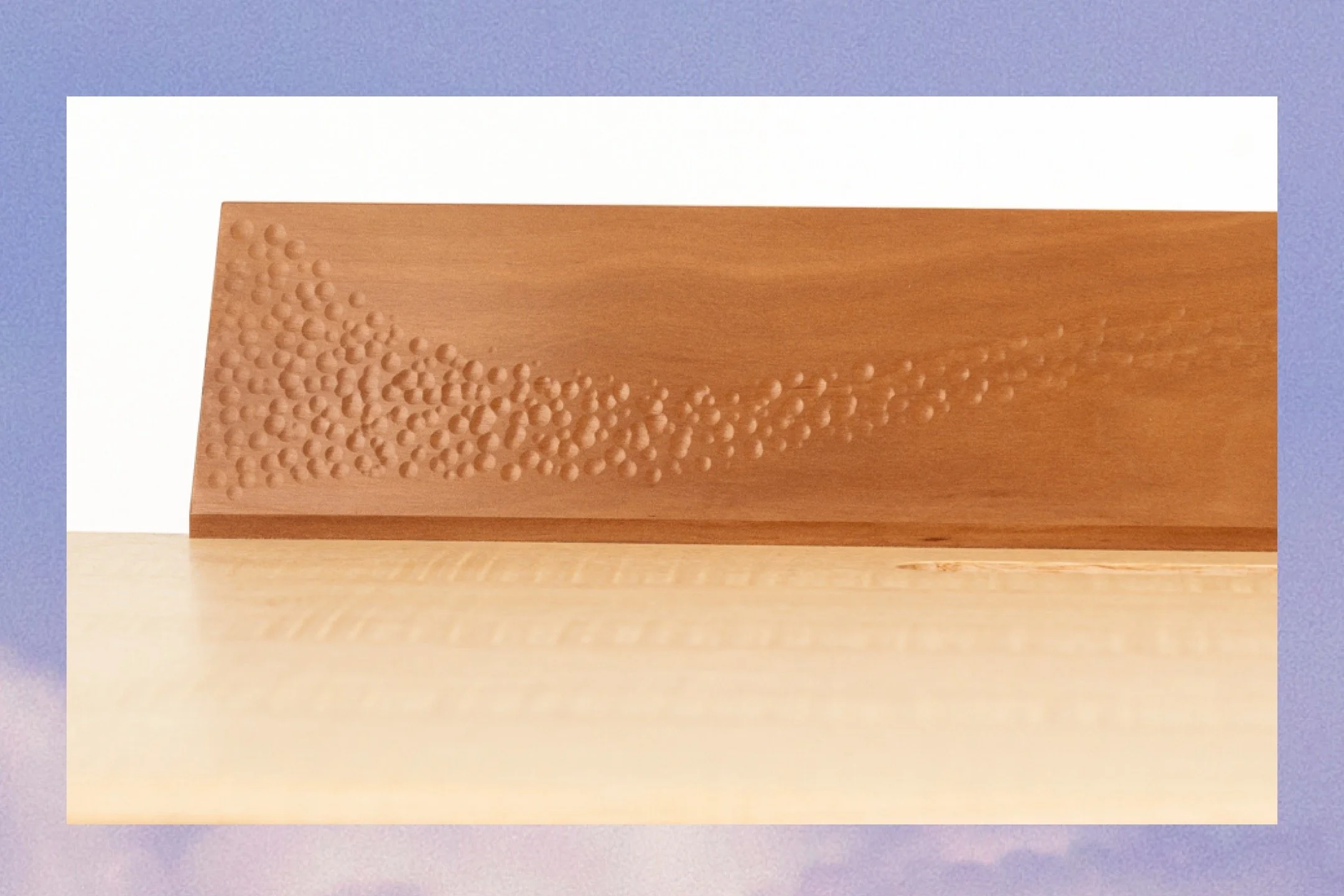 Hand-textured Swiss pear wood panel with a scattered dot relief pattern — surface detail work by furniture designer-maker Henry Crabb