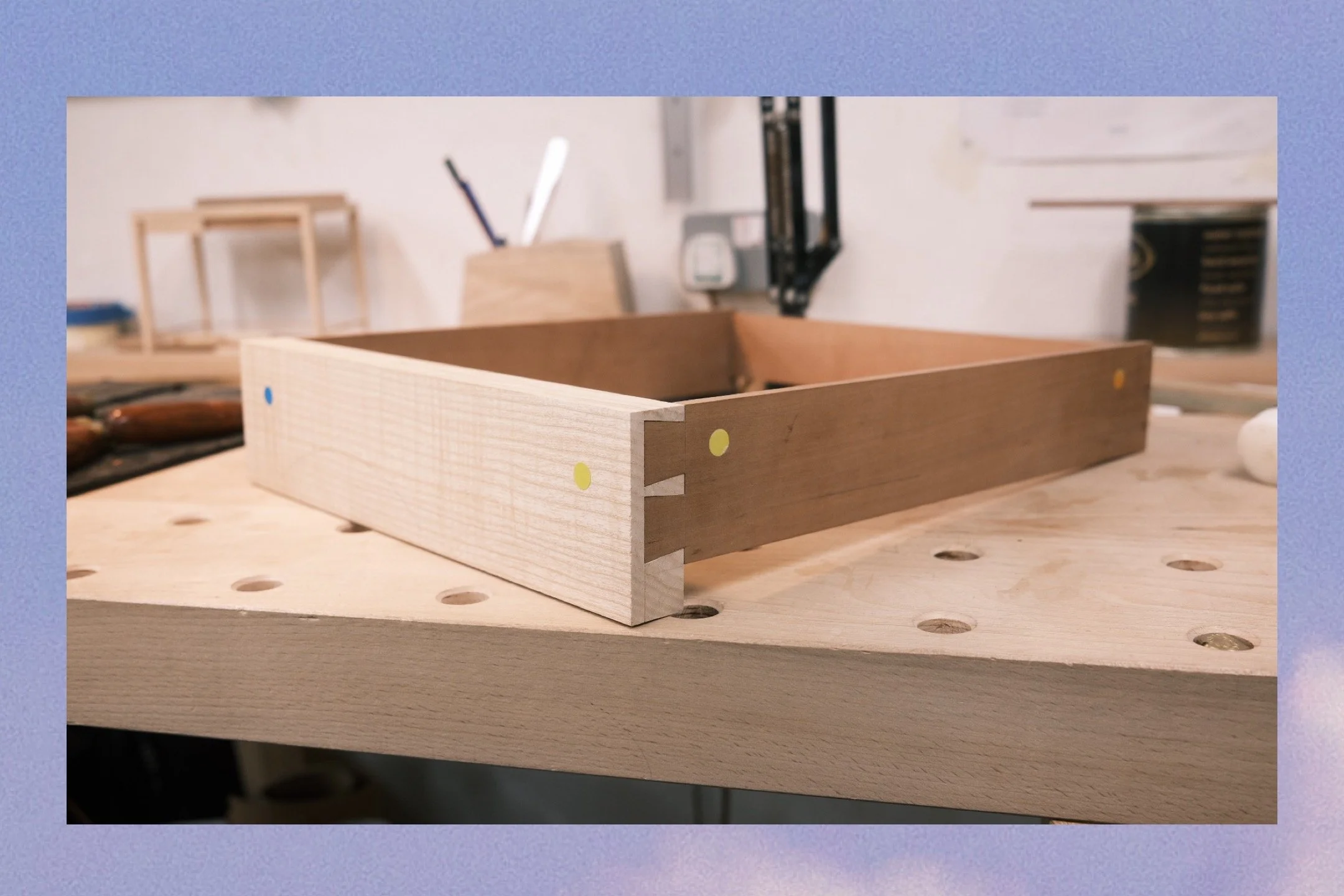 Ash and pear wood drawer construction with hand-cut dovetail joints, dry-fitted on a workbench at Henry Crabb's workshop, West Cornwall
