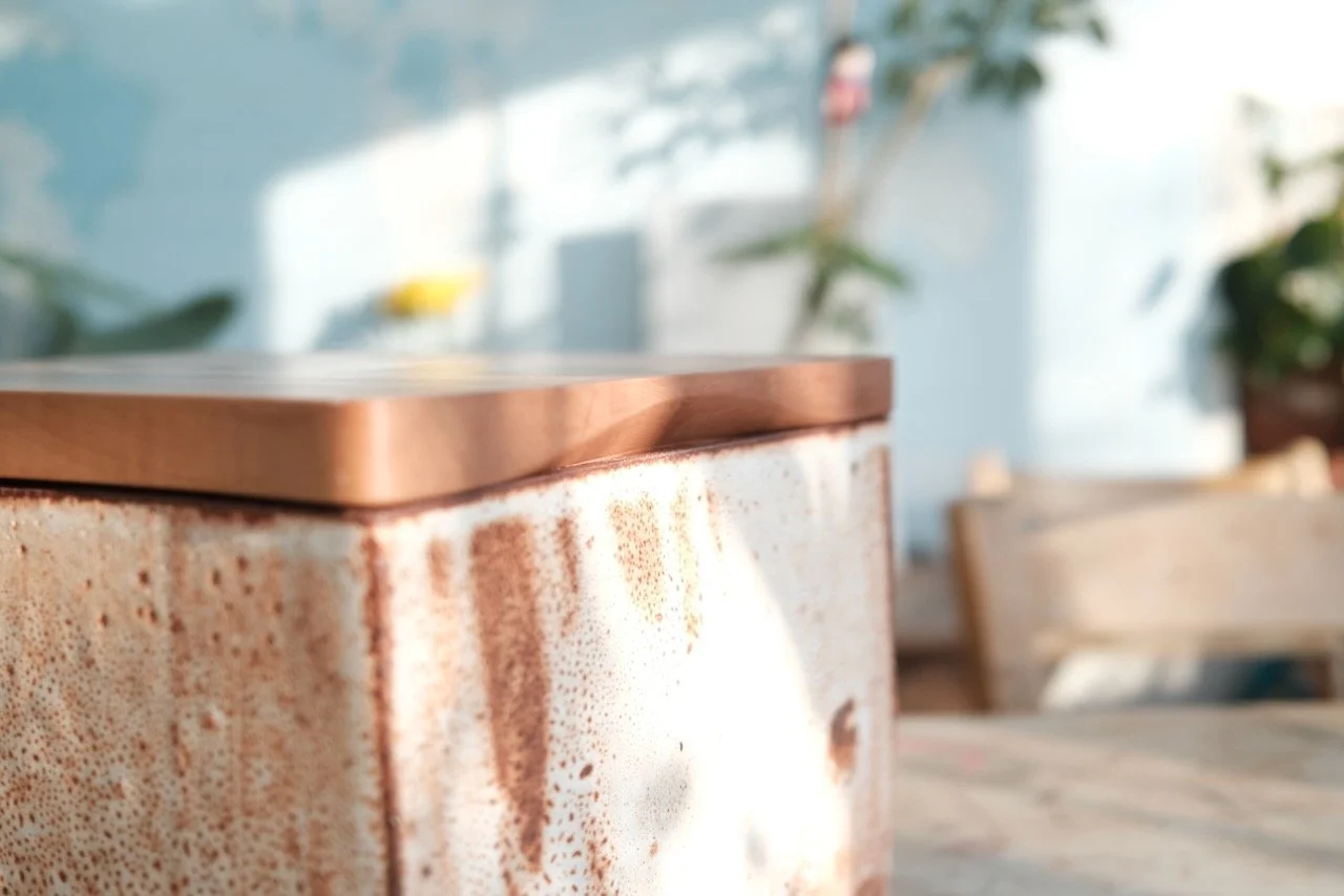 Detail of the Swiss pear wood cutting board lid resting on the shino-glazed Cornish clay body — handmade bread bin by Henry Crabb and Leach Pottery, St Ives