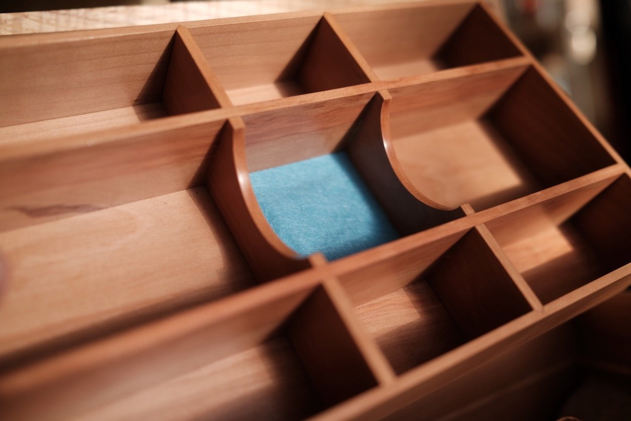 Engagement Box interior detail — English pear wood tray with curved ring box reveal and sapphire-dyed wool felt lining, hand-made by Henry Crabb