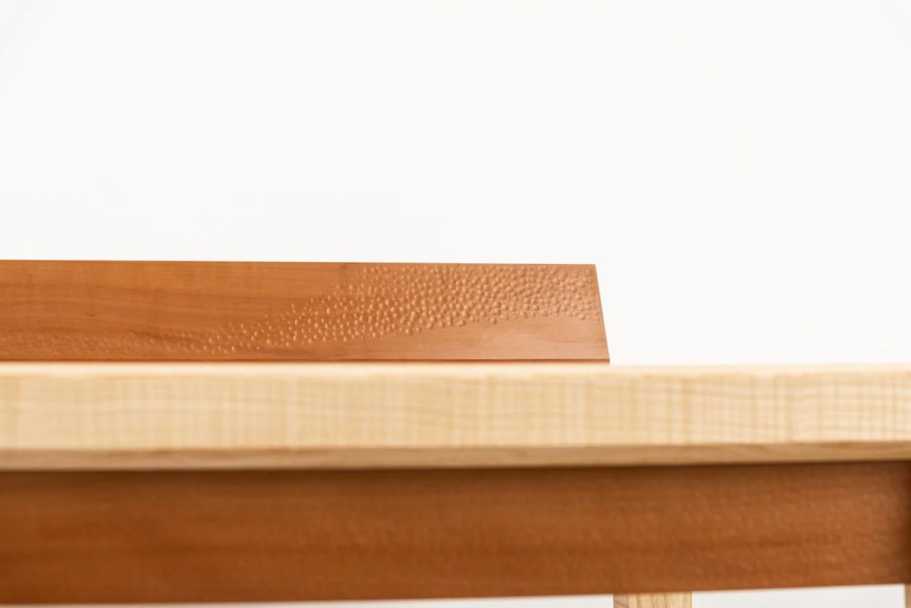 Journal Desk side profile — Swiss pear upstand rising above the rippled ash desktop, bespoke writing desk by Henry Crabb