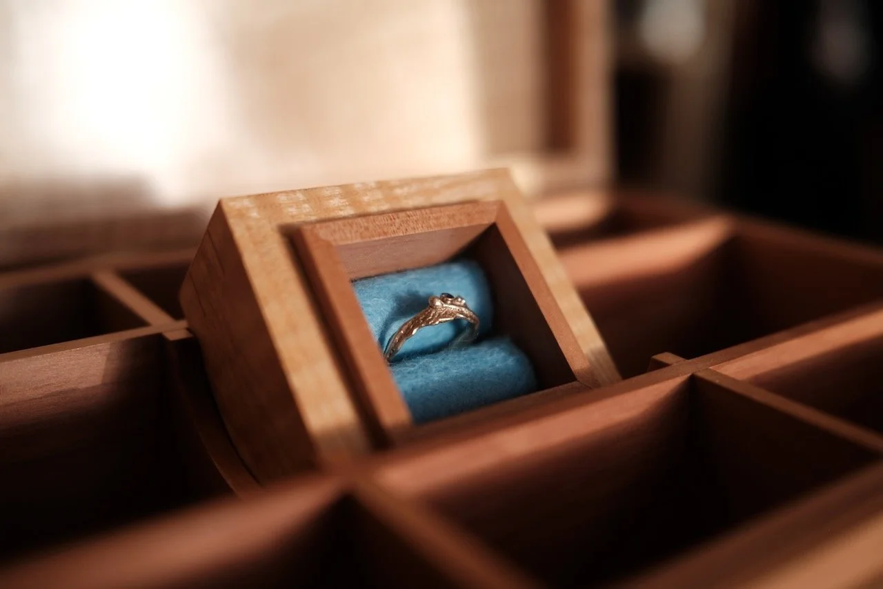 Sapphire ring nestled in a hand-made English pear wood ring box lined with sapphire-dyed English wool felt — Engagement Box by Henry Crabb