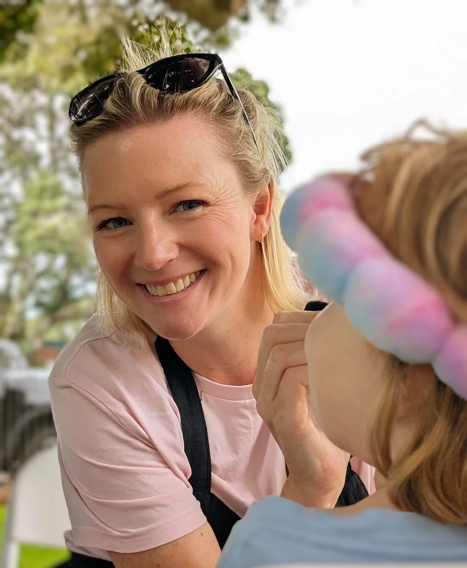 Belle from Faceology face painting a child