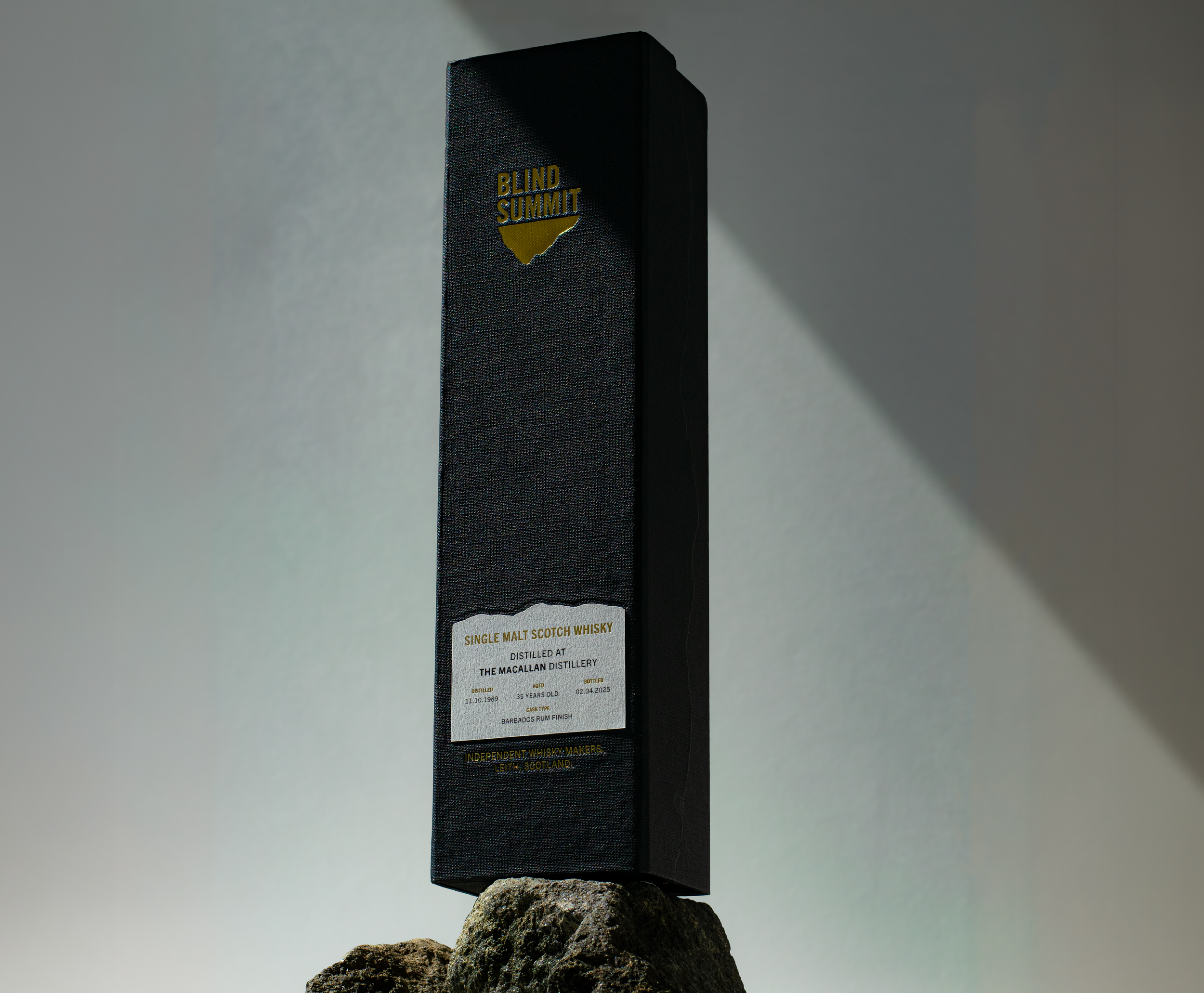 The Blind Summit Macallan box displayed on a dark rock.
