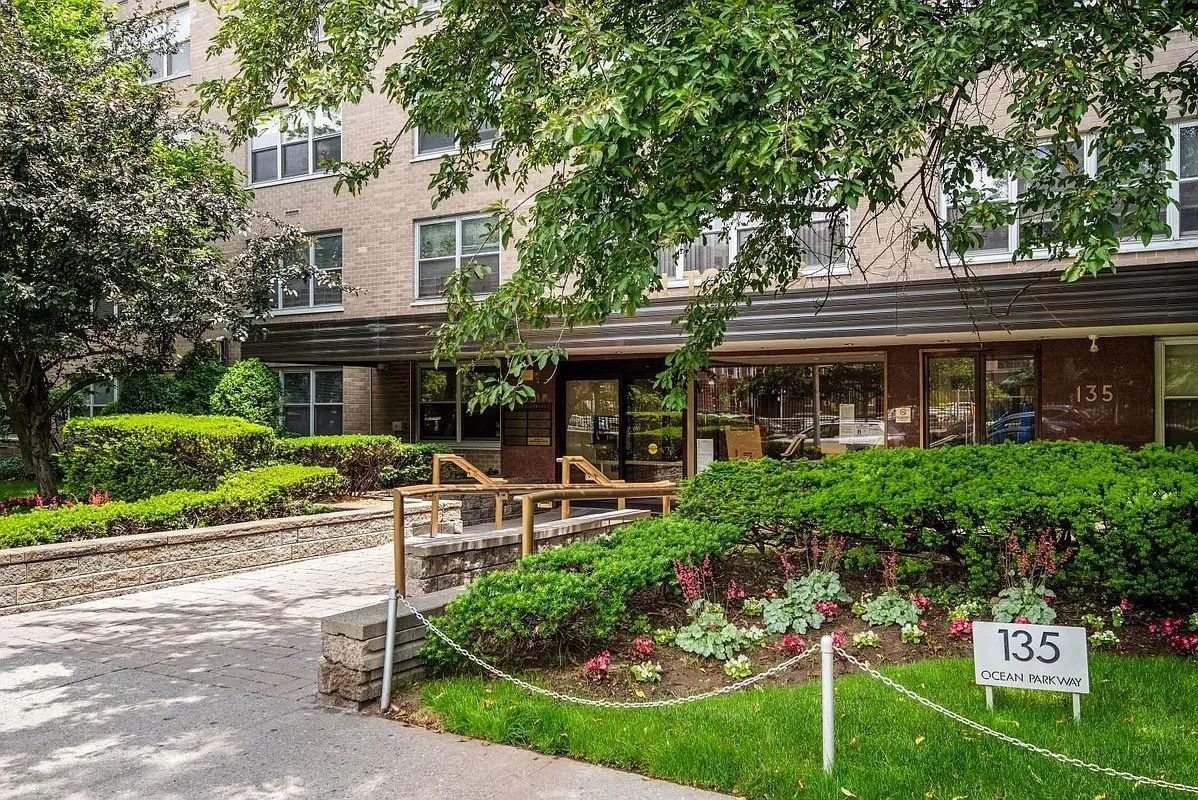 Street view of the entrance to the building housing therapy offices for rent in Brooklyn, with landscaped greenery.