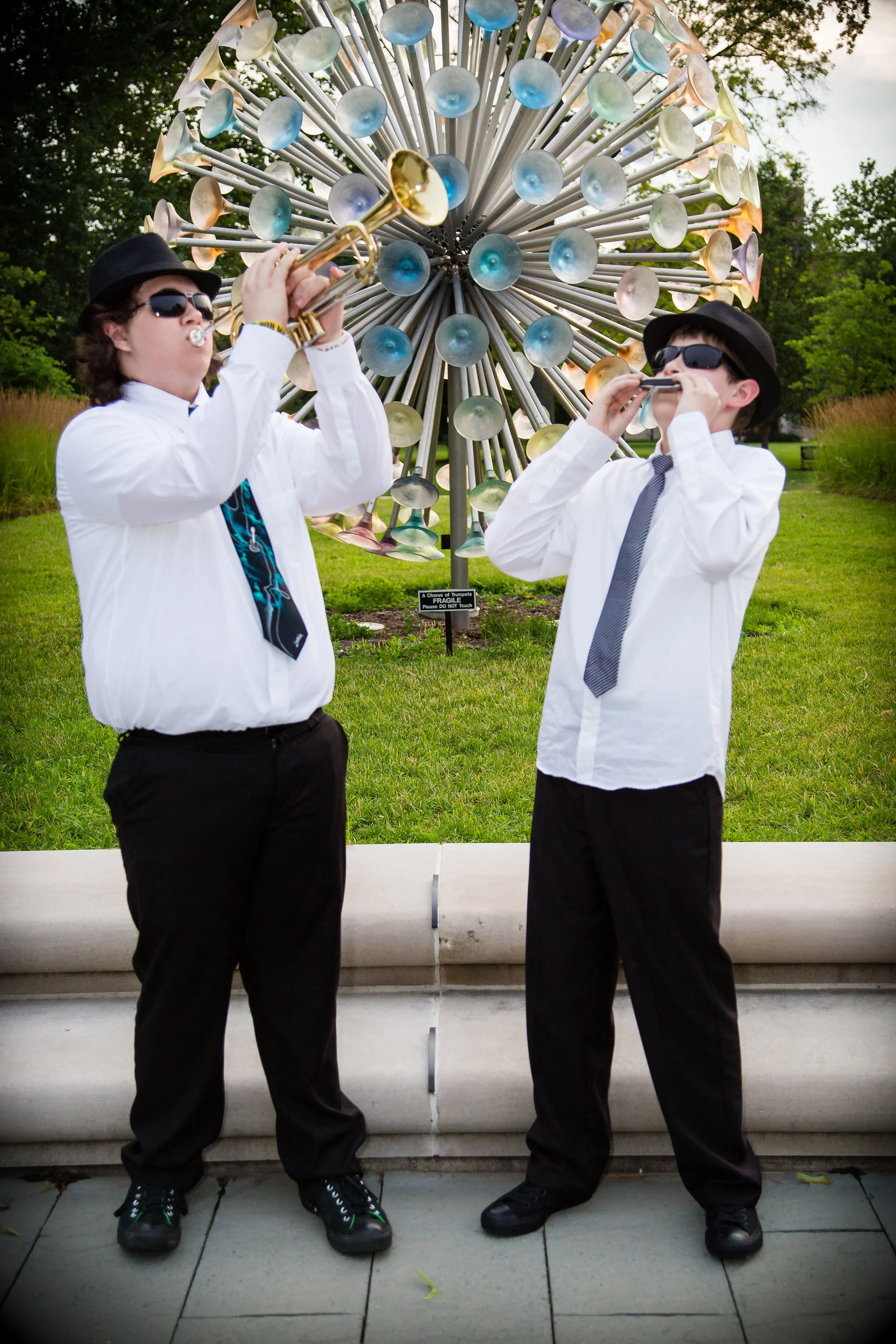 A creative and fun high school senior portrait session featuring a young man and his little brother mimicking the Blues Brothers on the Indiana State University (ISU) campus in Terre Haute, Indiana.