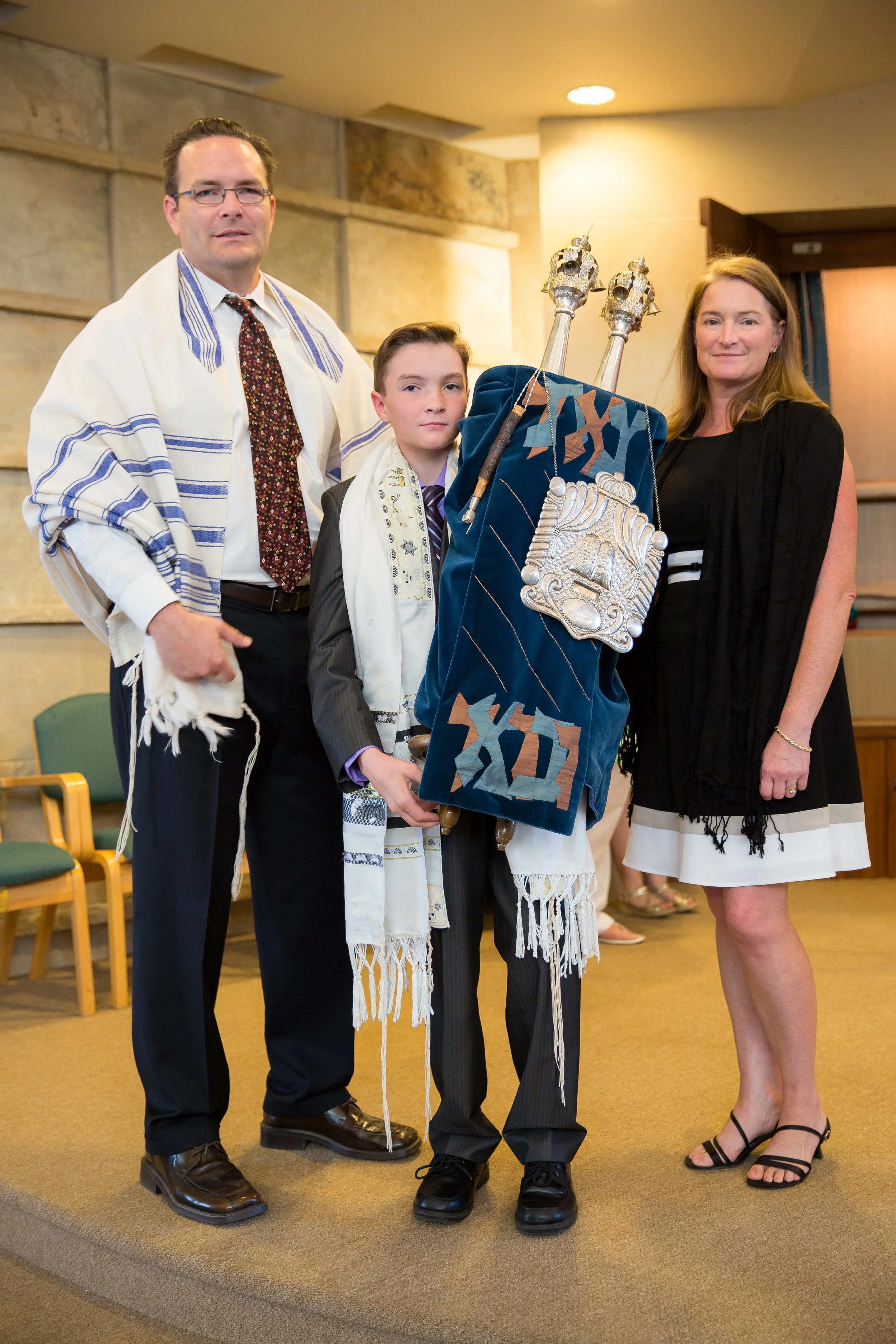 A meaningful family portrait session of a young boy with his parents during his Bar Mitzvah rehearsal at Congregation Har HaShem in Boulder, Colorado.