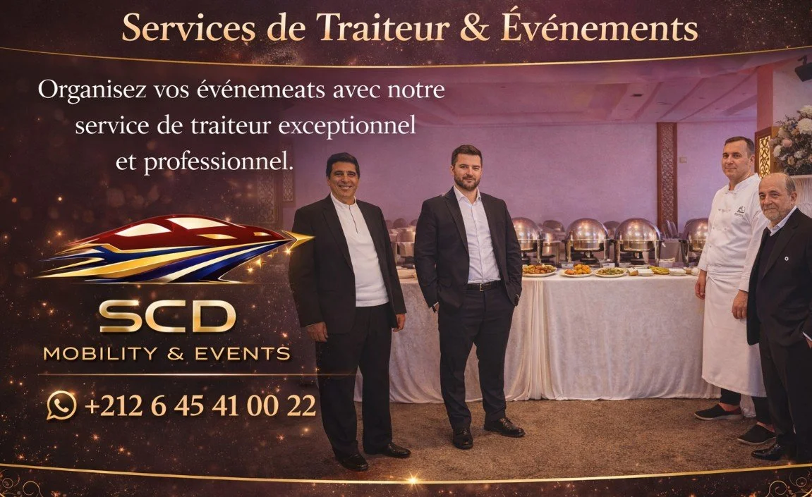 Sign in French advertising catering services and events, with a photo of four smiling men standing in front of a buffet table with covered chafing dishes, and contact information including a WhatsApp number.