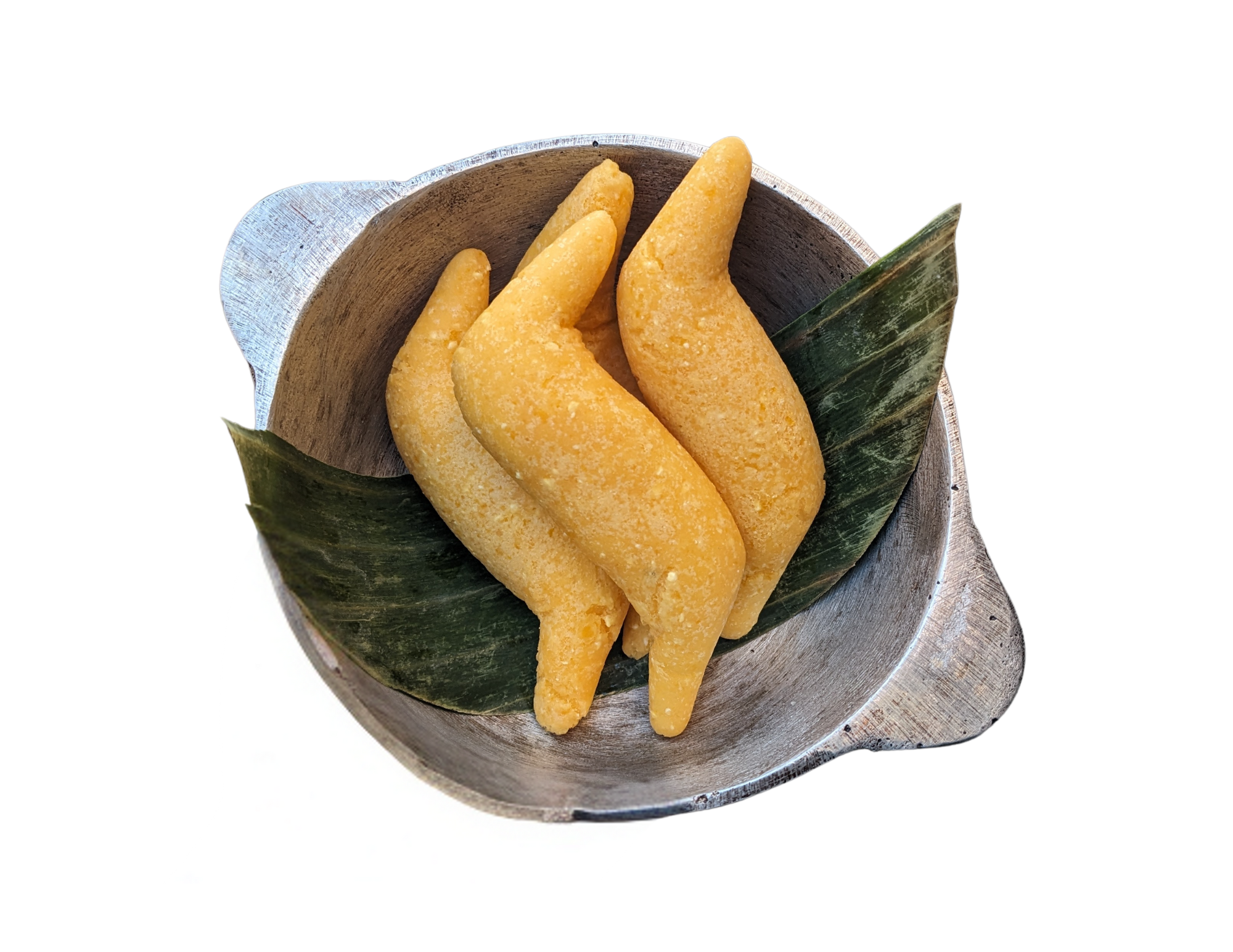 Four pieces of frozen yellow mango slices in a wooden bowl lined with green banana leaf.
