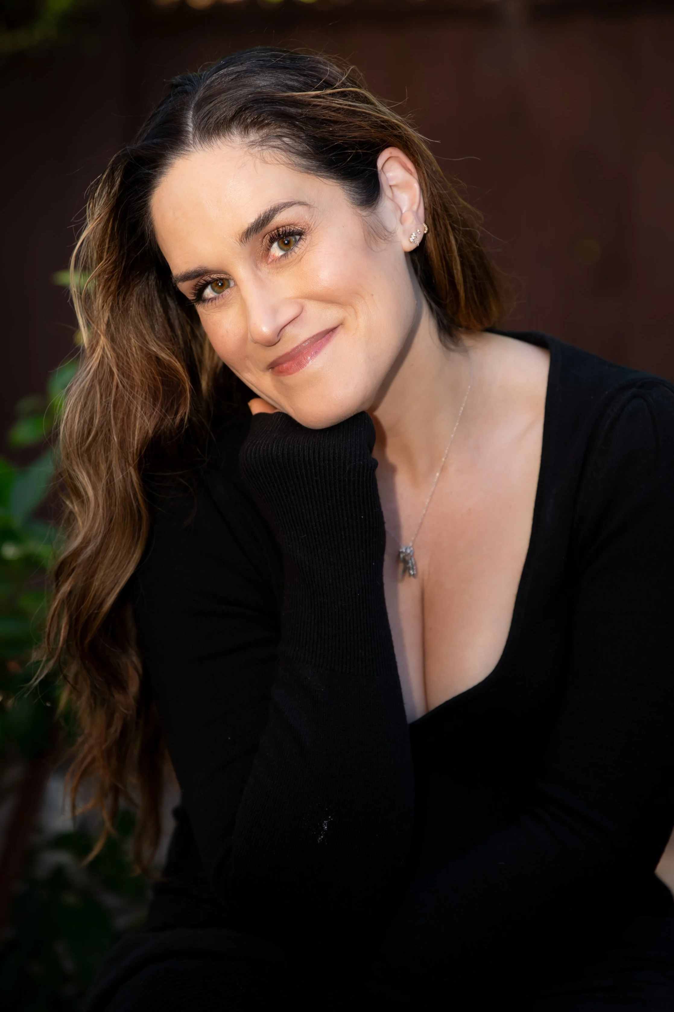 Portrait of journalist and author Michelle Konstantinovsky wearing a black outfit.