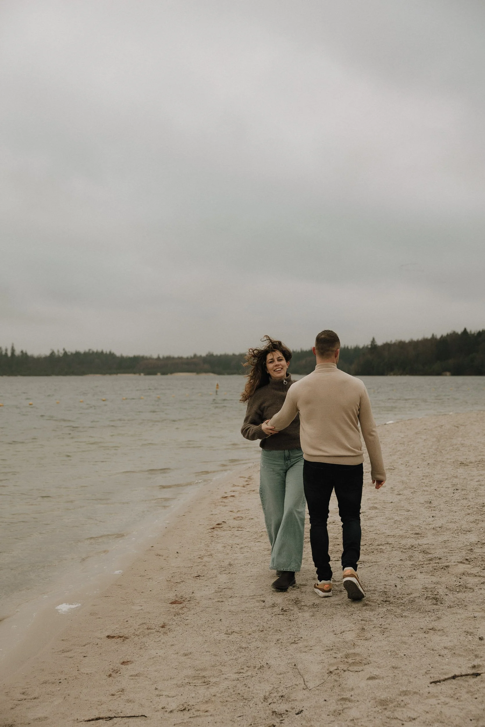 Koppel fotoshoot bij Het Hemelriekje in Borger – verliefd stel rent samen door het zand in cinematic lifestyle stijl