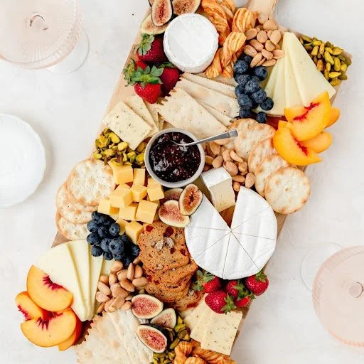 Cheese board with dried fruits, quince paste and crackers