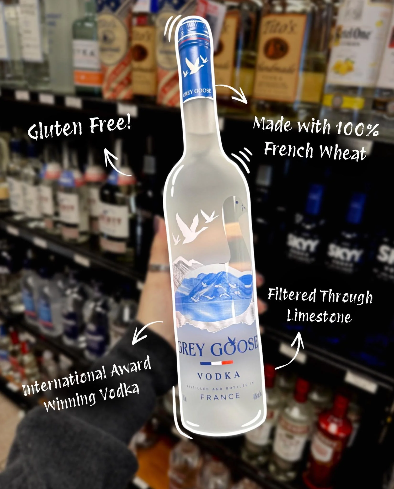 A person holding a Grey Goose vodka bottle with overlay text highlighting its features: gluten free, made with 100% French wheat, filtered through limestone, and an award-winning vodka branding.