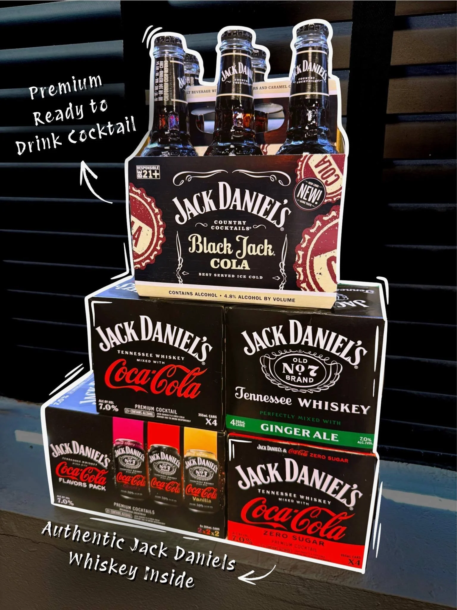 Display of Jack Daniel's products, including a six-pack of Black Jack Cola bottles on top, Jack Daniel's Coca-Cola flavored pack, Jack Daniel's Old No. 7 Tennessee Whiskey mixed with ginger ale, and Jack Daniel's Coca-Cola zero sugar cans. Handwritte