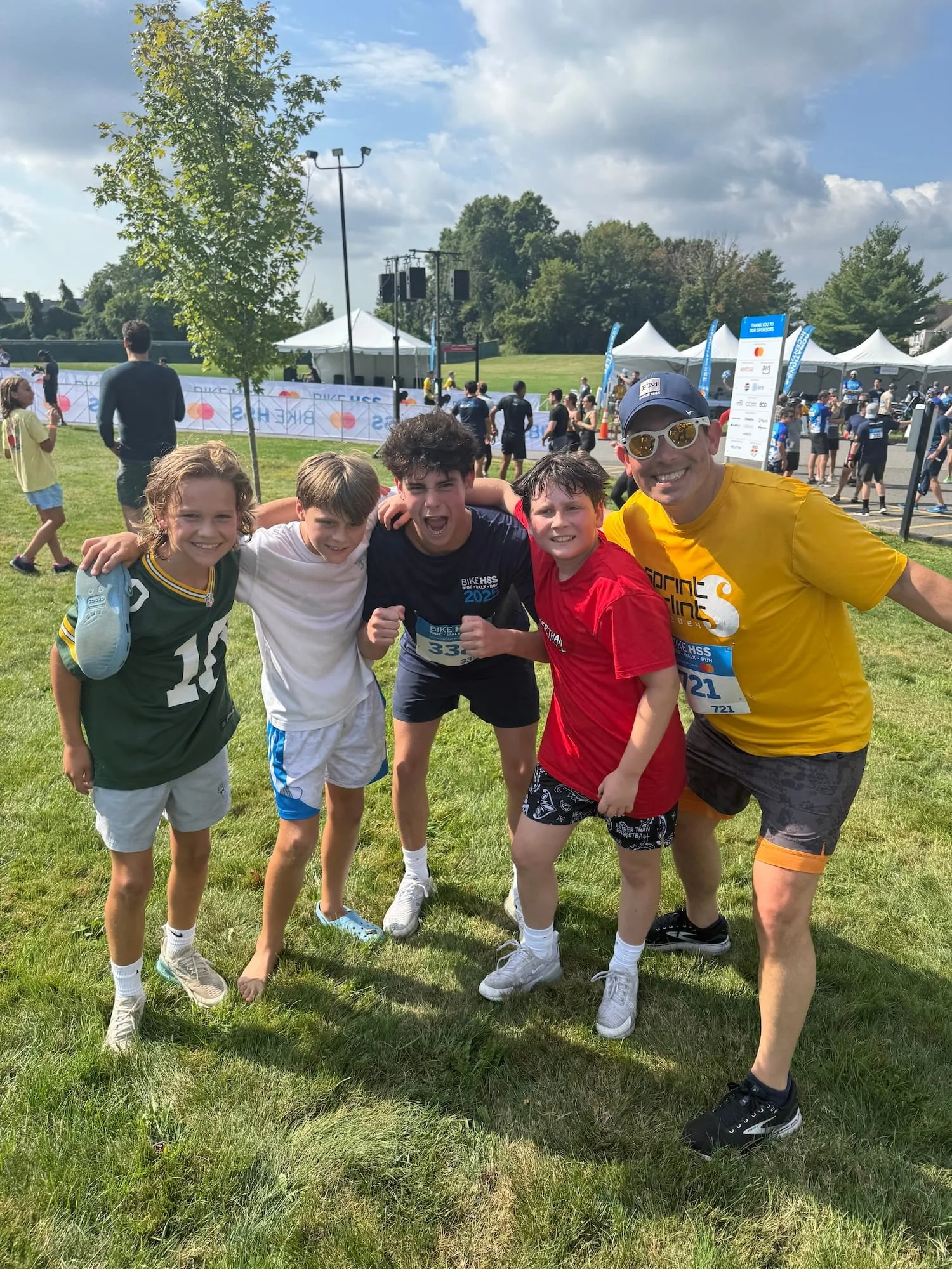 Jonah Schwartz and friends at outdoor charity race celebrating together with race bibs