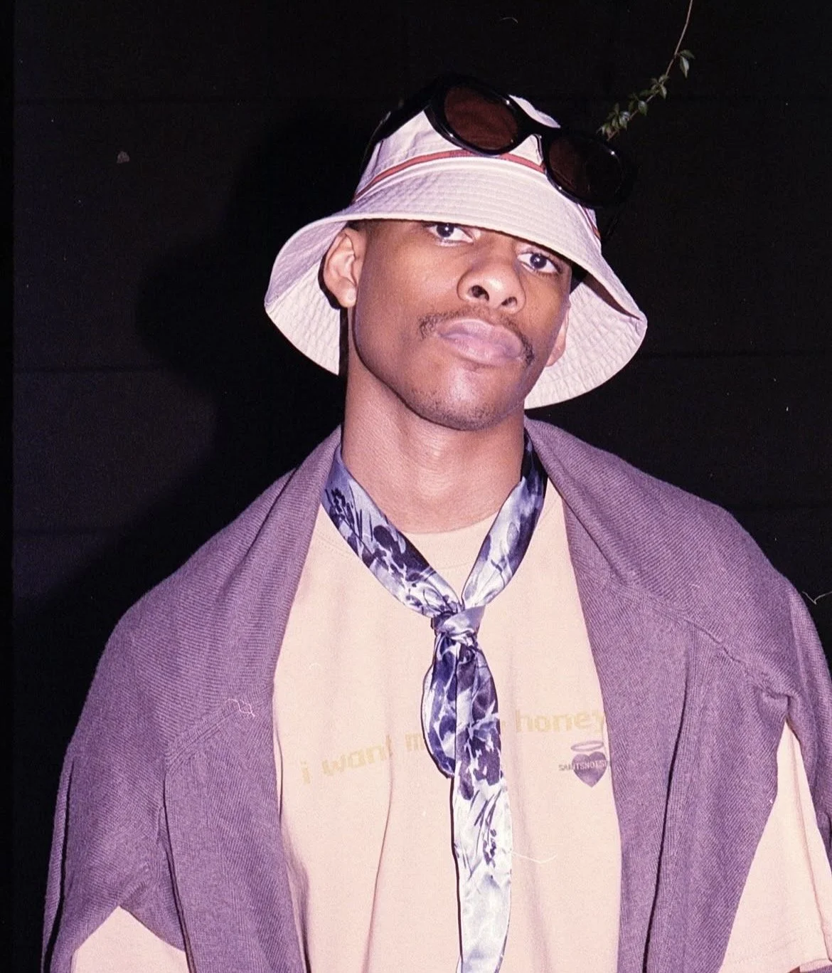 Tobacco Ryan with a bucket hat , sunnies , cardigan and ascot