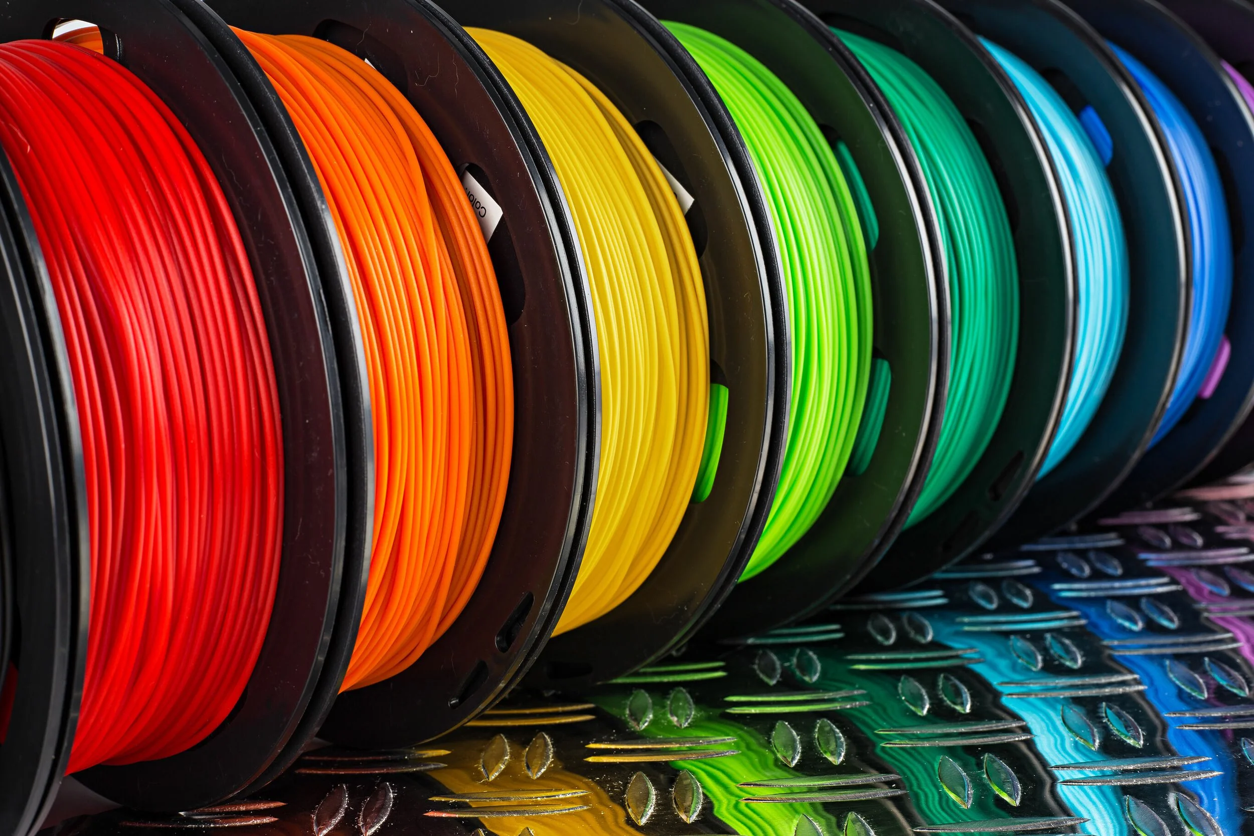 a rainbow assortment of pla plastic spools