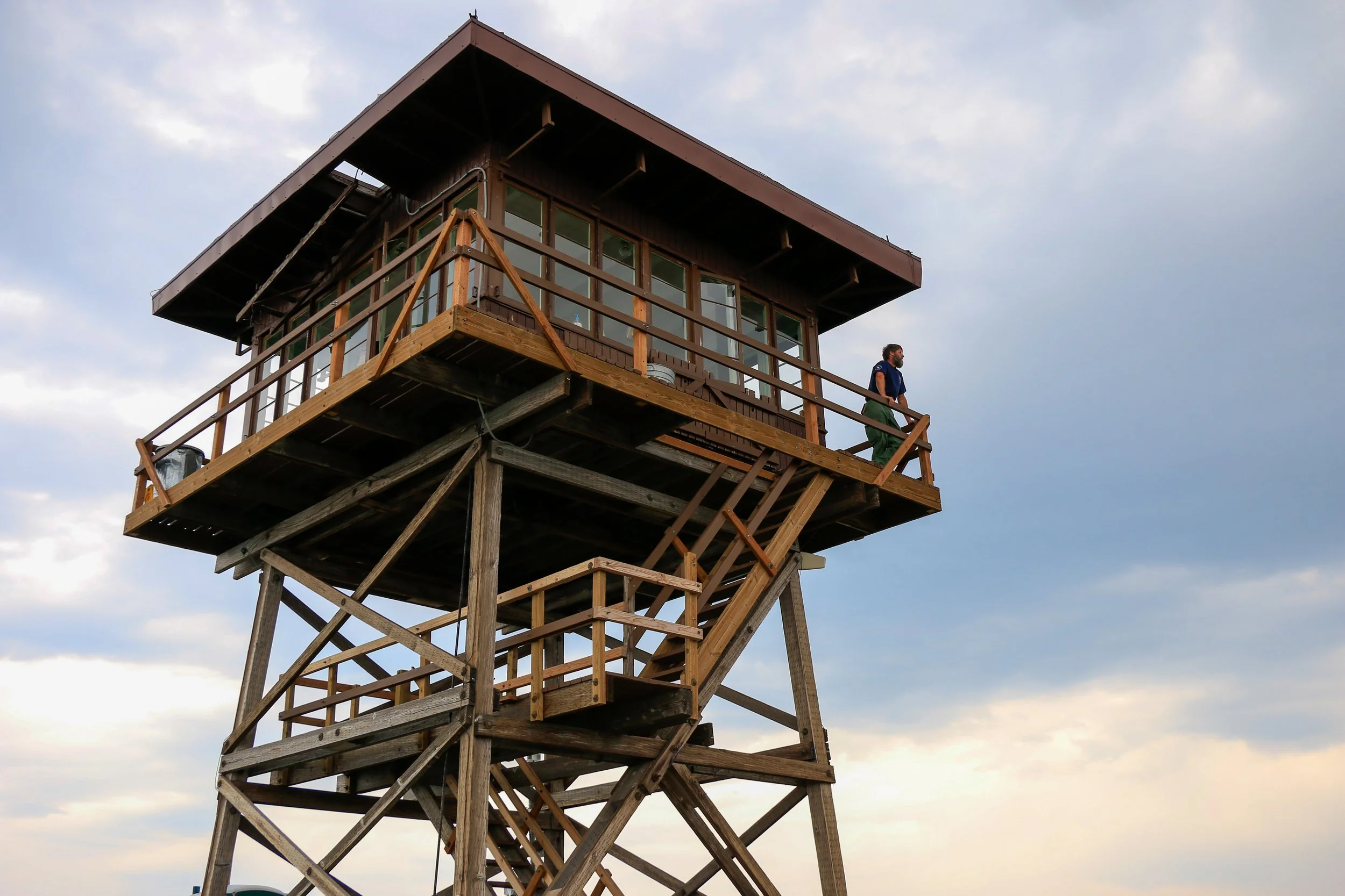 Lookout Tom Wegner scans the horizon from the Stark Mountain Fire Lookout in the Lolo National Forest of western Montana.