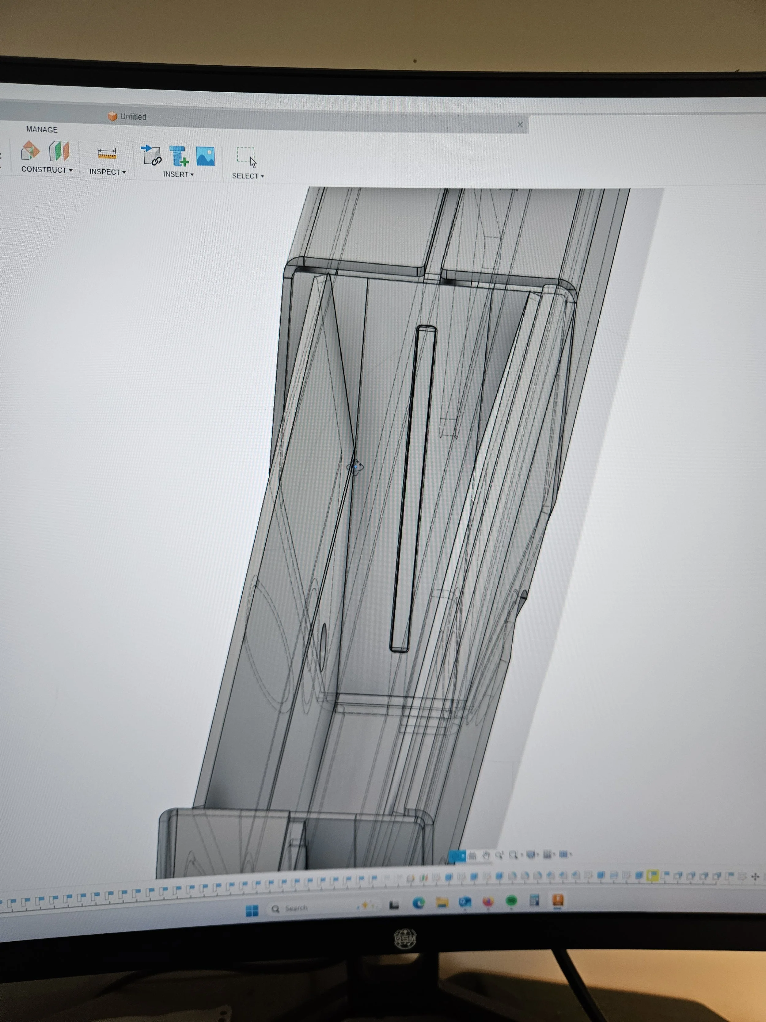 Computer screen displaying a 3D CAD design of a tall, rectangular object with detailed lines and sections, likely a piece of furniture or equipment.