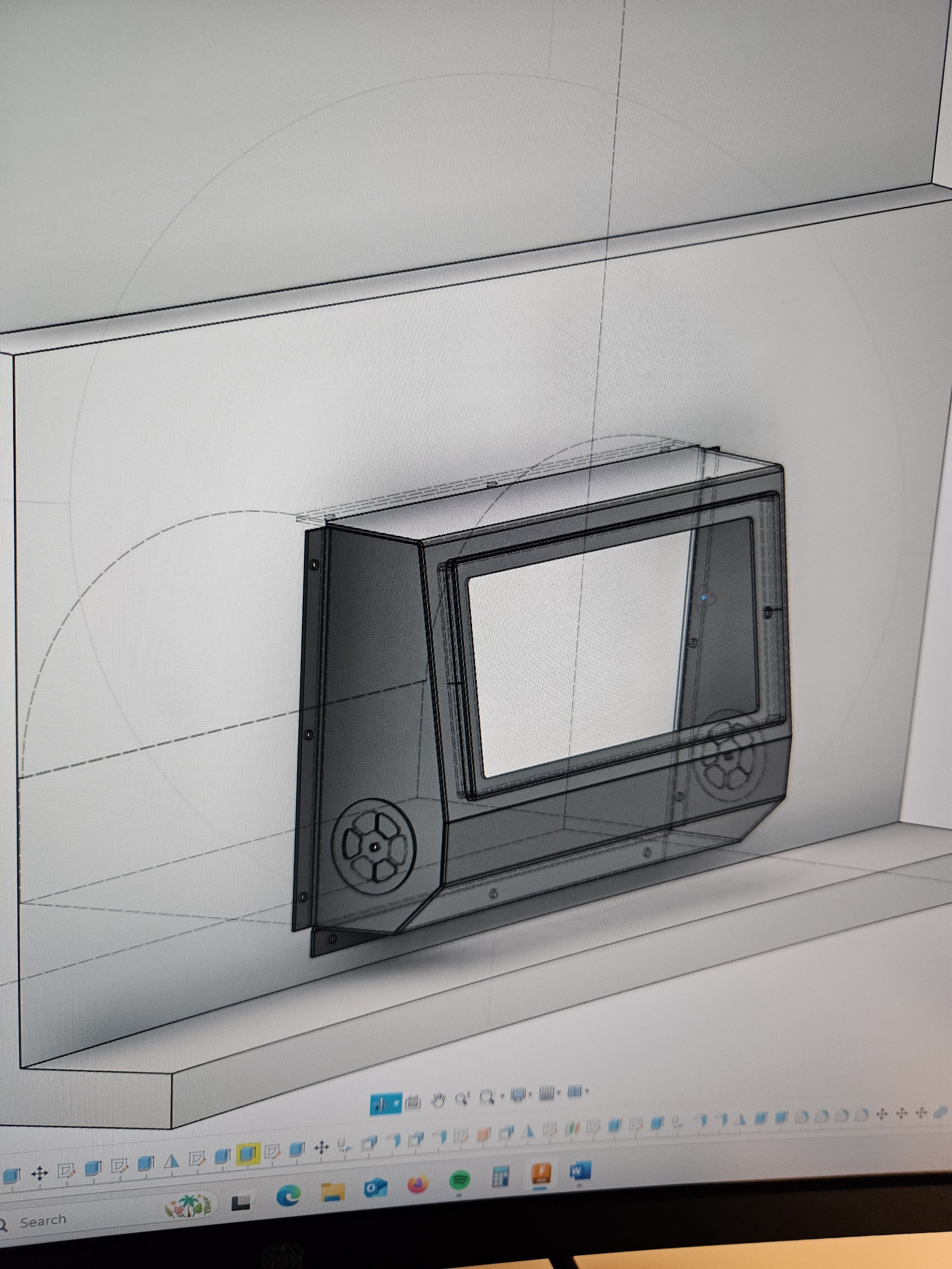 Computer-aided design (CAD) drawing of a wall-mounted entertainment or control panel with a screen and circular control buttons on each side.