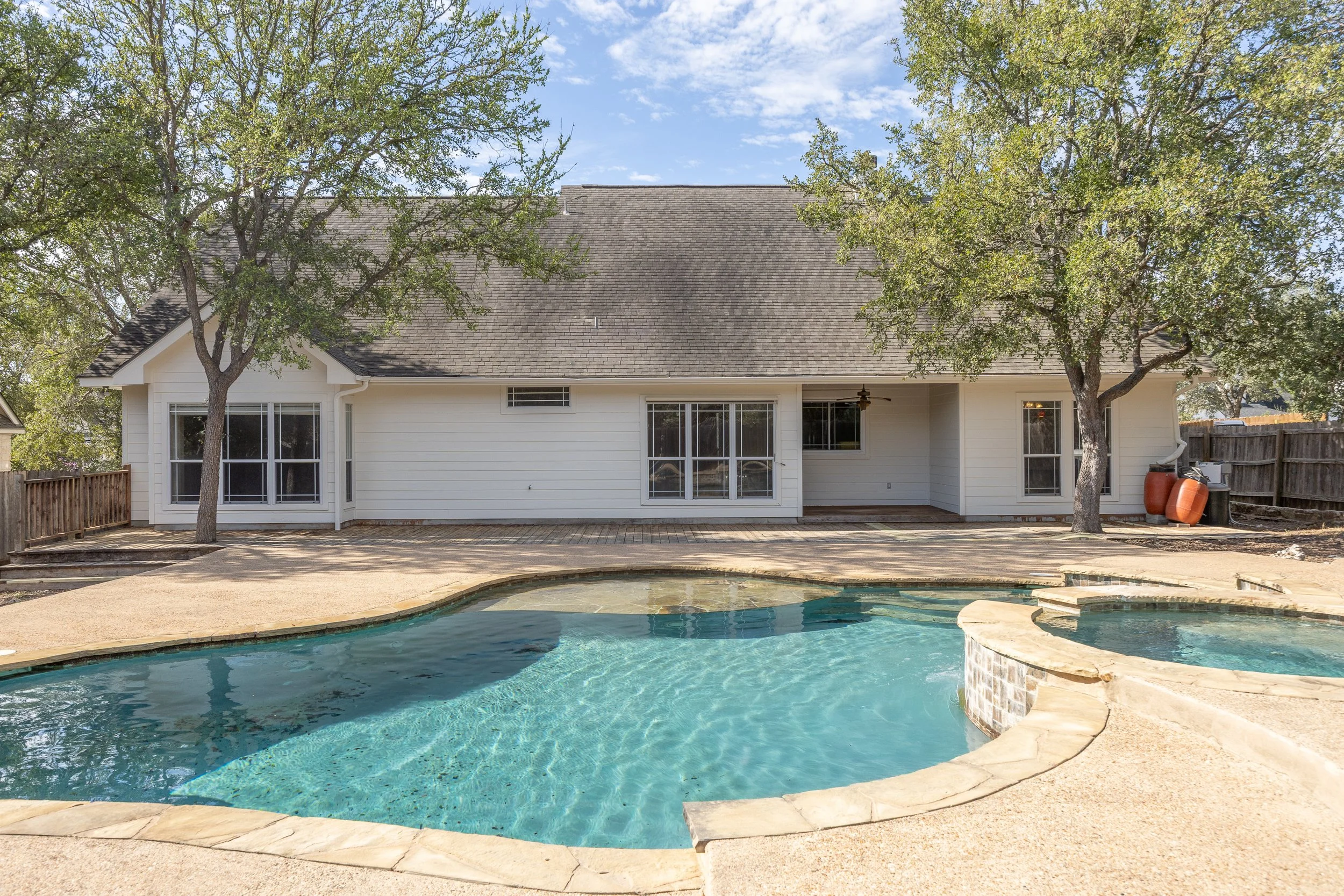 Designed for easy upkeep, the low-maintenance grounds feature a private back deck and an extraordinary backyard retreat—complete with a sparkling in-ground pool, serene waterfall, relaxing spa, and waterslide.