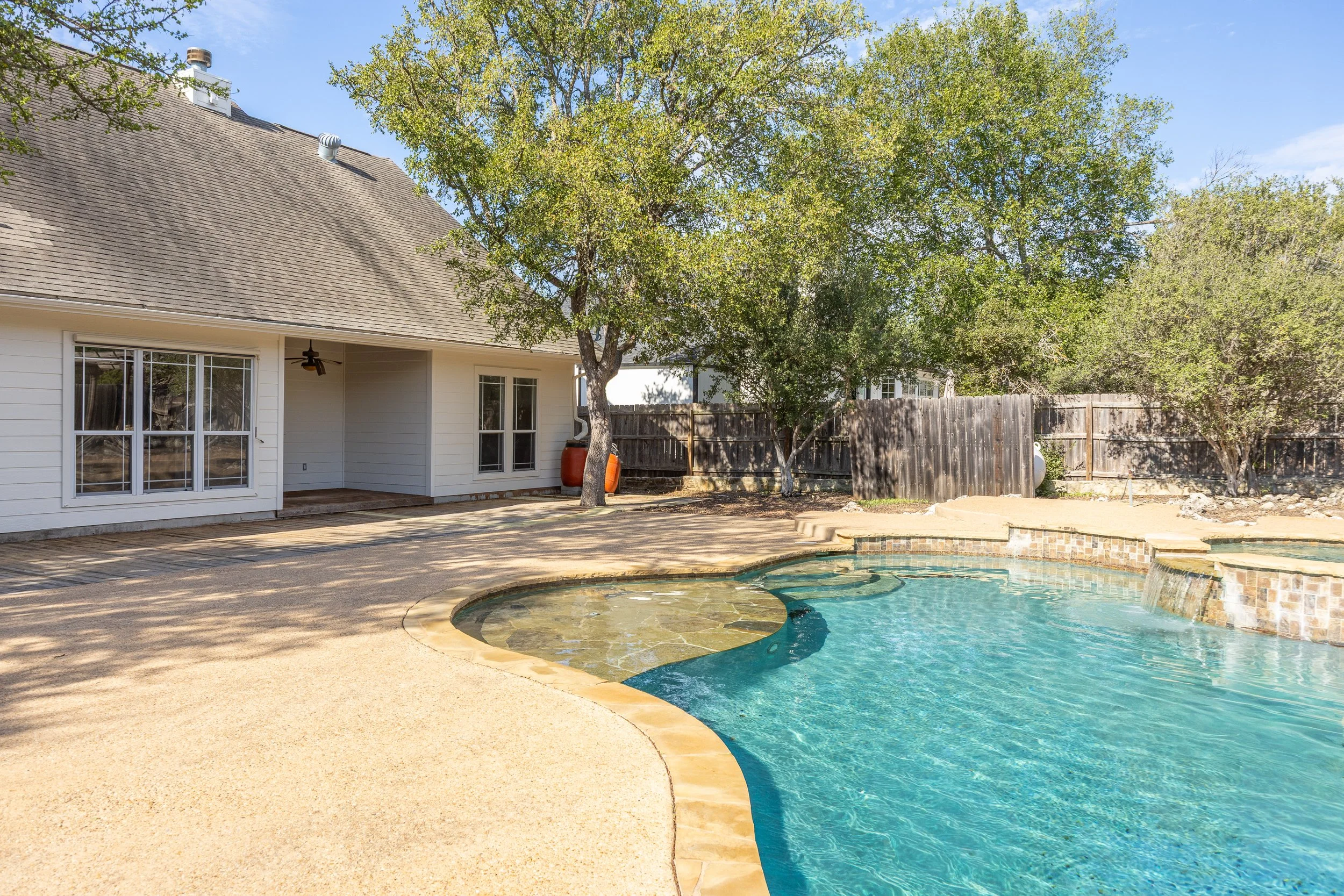 Designed for easy upkeep, the low-maintenance grounds feature a private back deck and an extraordinary backyard retreat—complete with a sparkling in-ground pool, serene waterfall, relaxing spa, and waterslide.