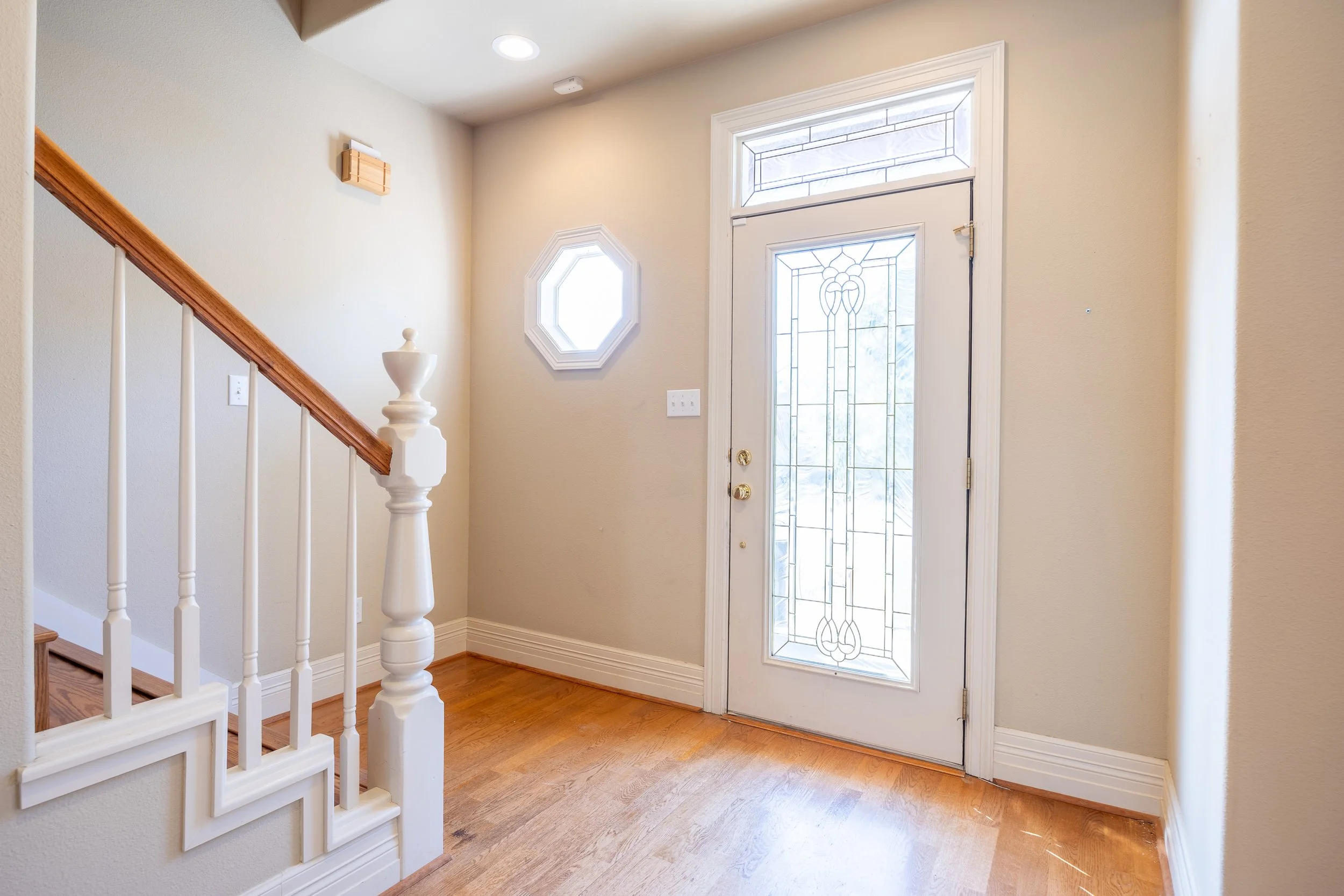 The interior features a large living room and a flexible Mother-in-Law floor plan, with rich hardwood floors and abundant natural light.
