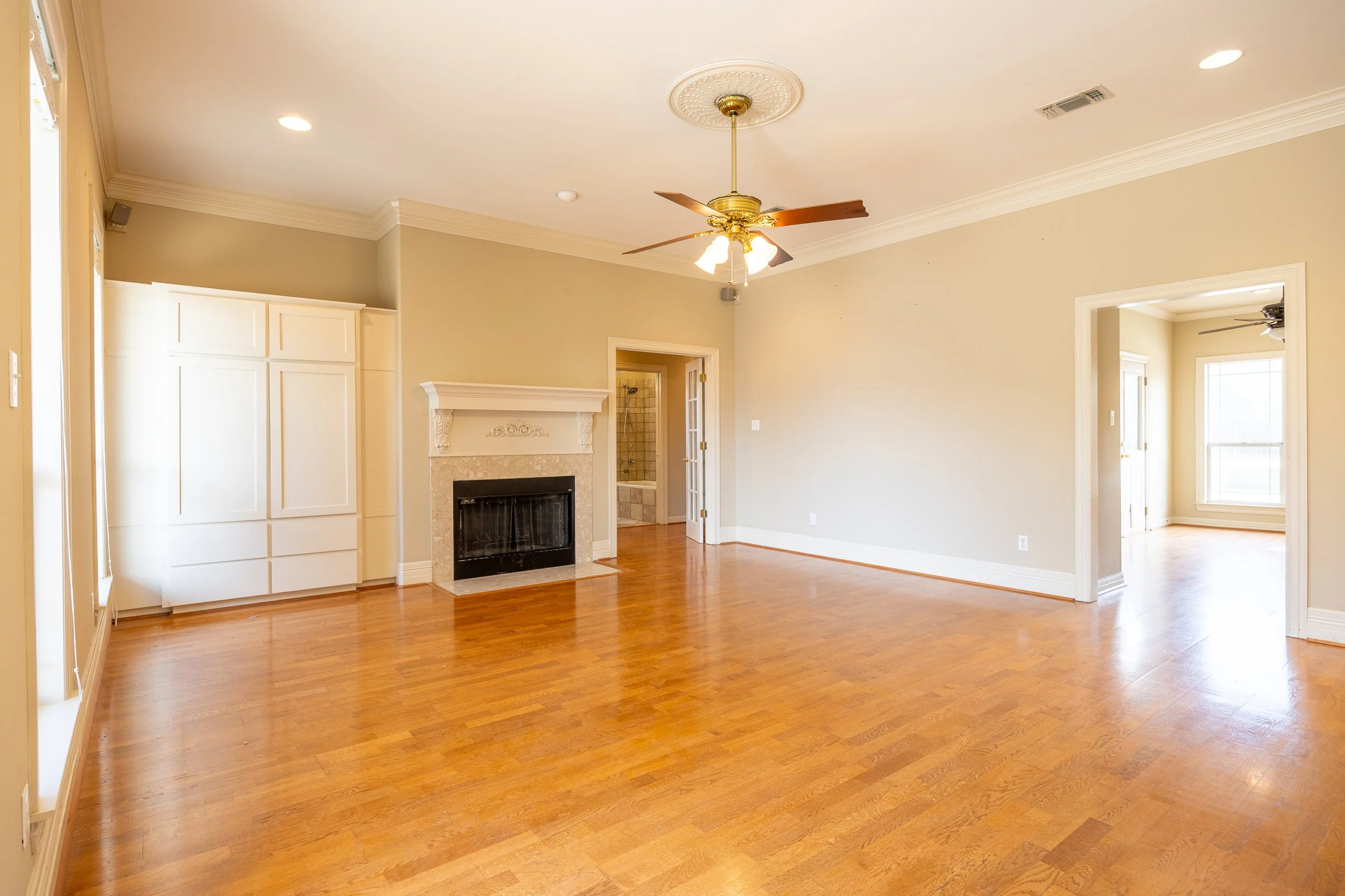 The interior features a large living room and a flexible Mother-in-Law floor plan, with rich hardwood floors and abundant natural light.