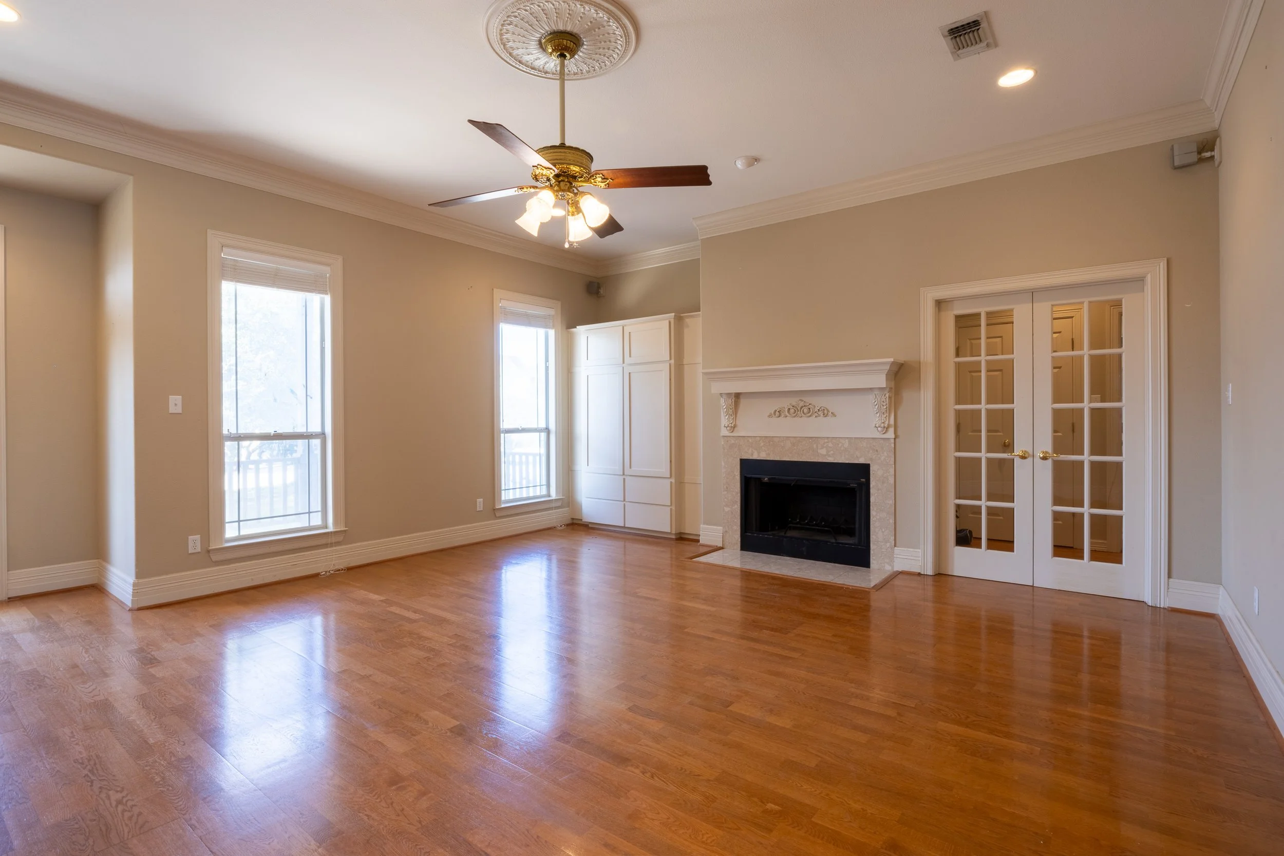 The interior features a large living room and a flexible Mother-in-Law floor plan, with rich hardwood floors and abundant natural light.