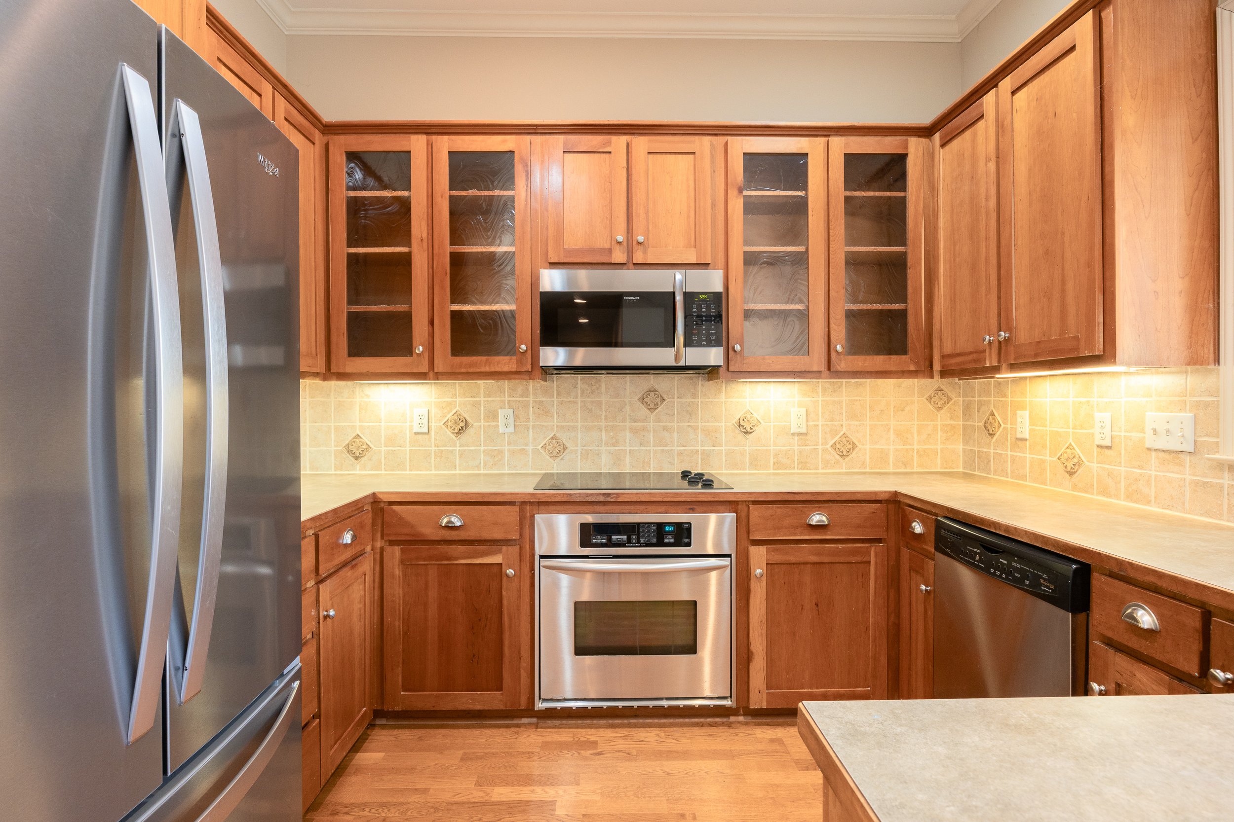 At the heart of the home, the modern kitchen features stainless steel appliances and an integrated water softener system.