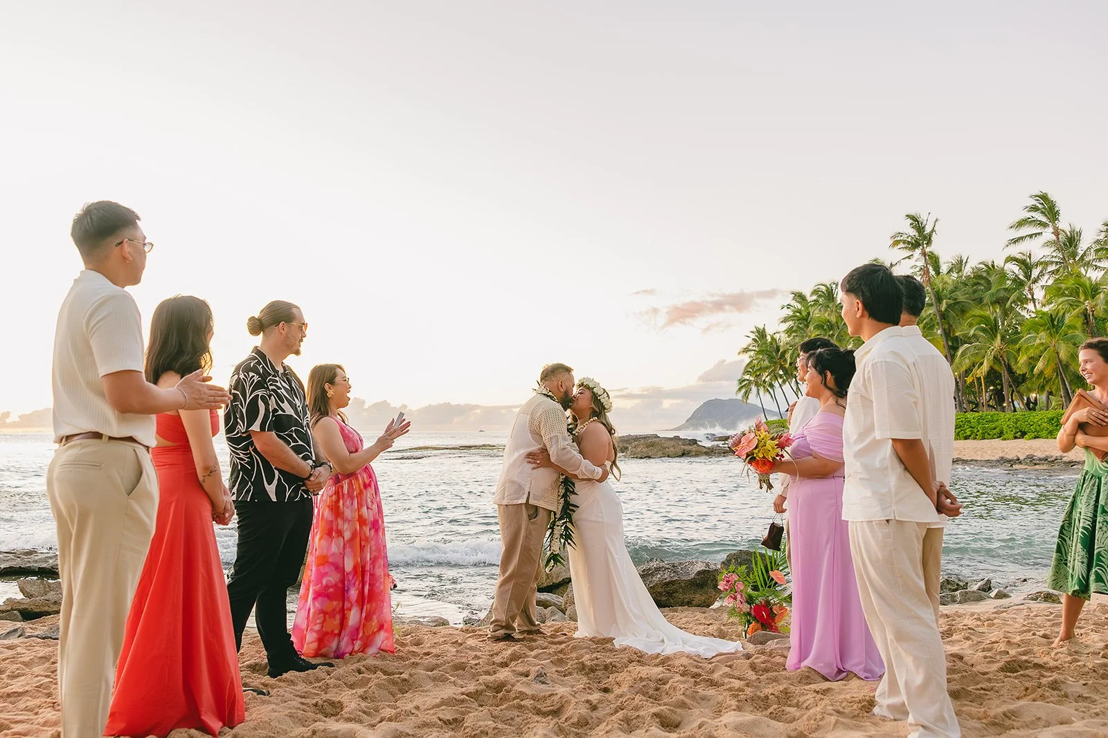 Couple standing together by the ocean, with an intimate beach wedding ceremony shown nearby.